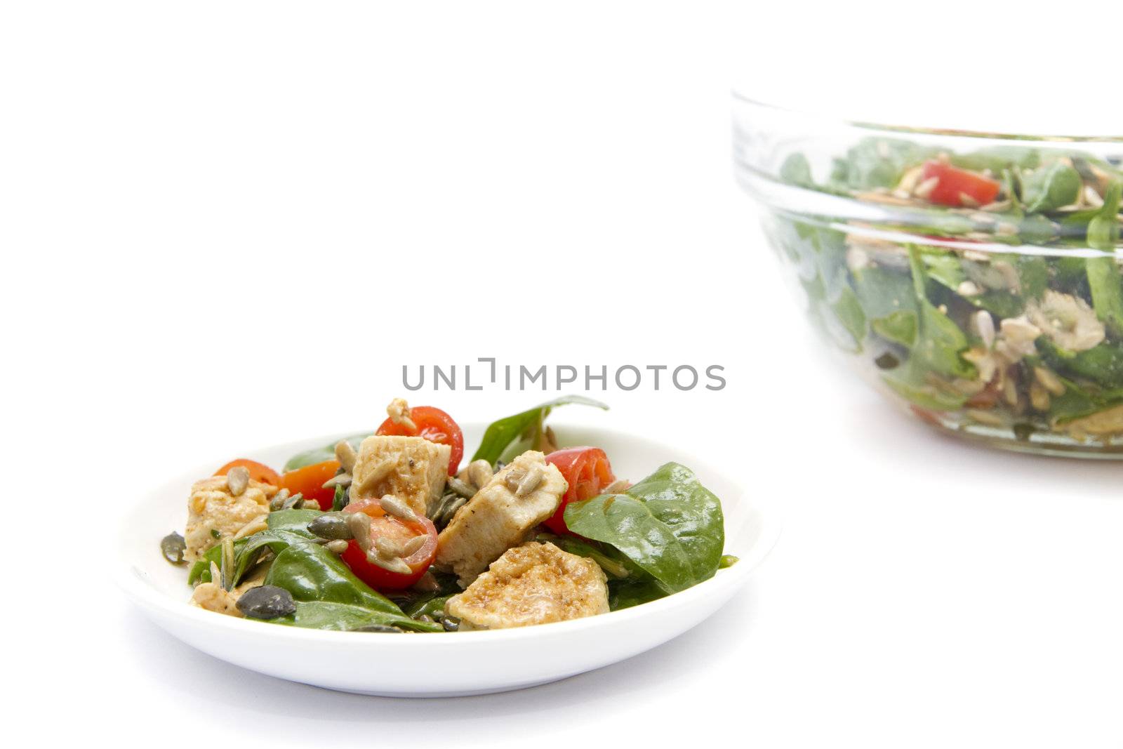 Spinach and chicken salad over white background