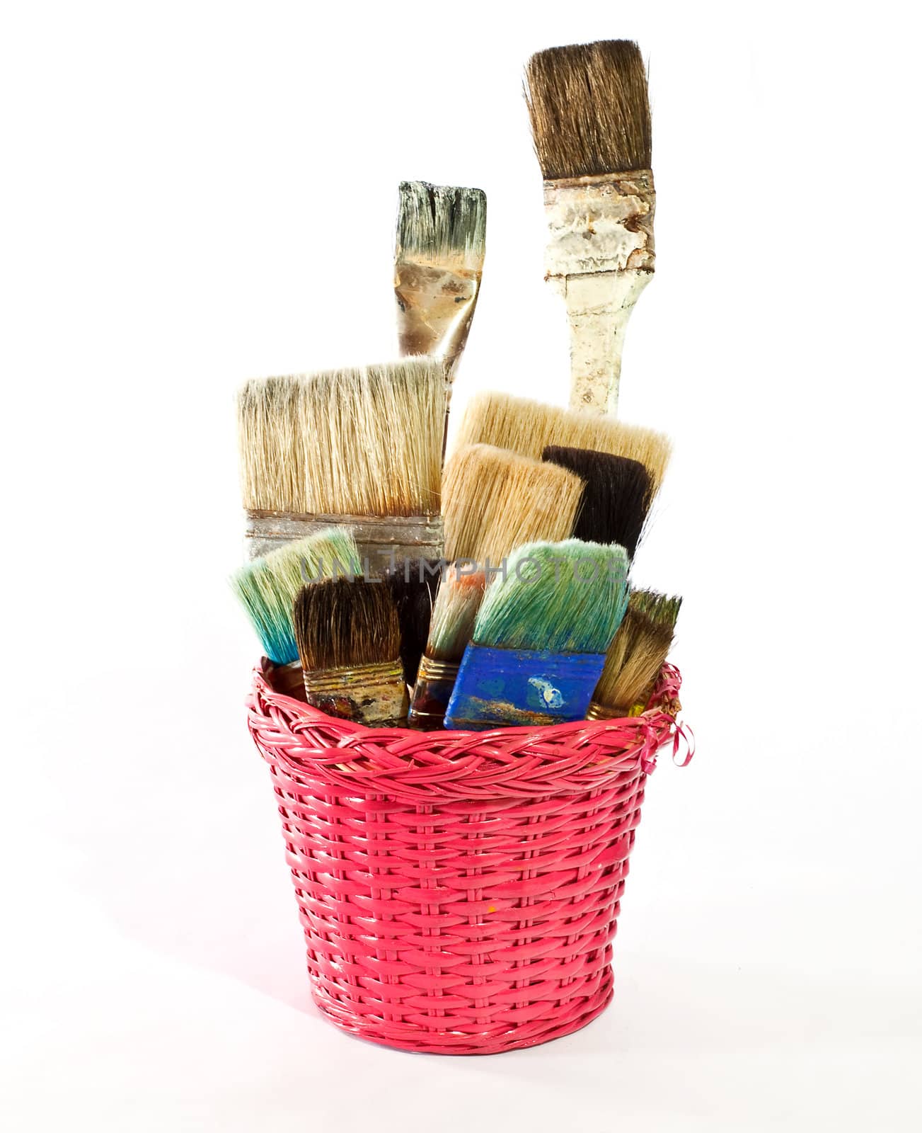 Various used Paintbrushes in a wicker basket