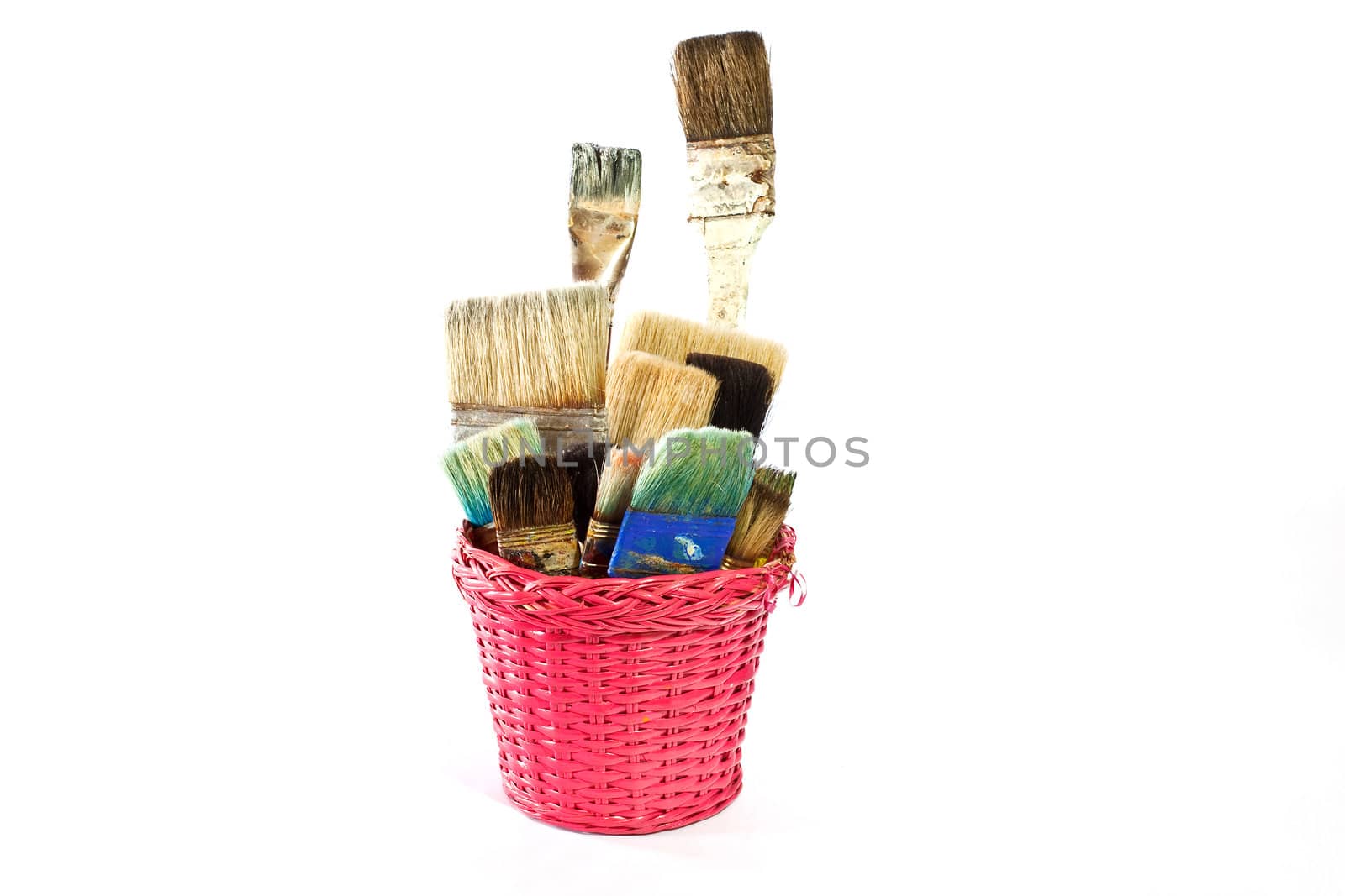 Various used Paintbrushes in a wicker basket