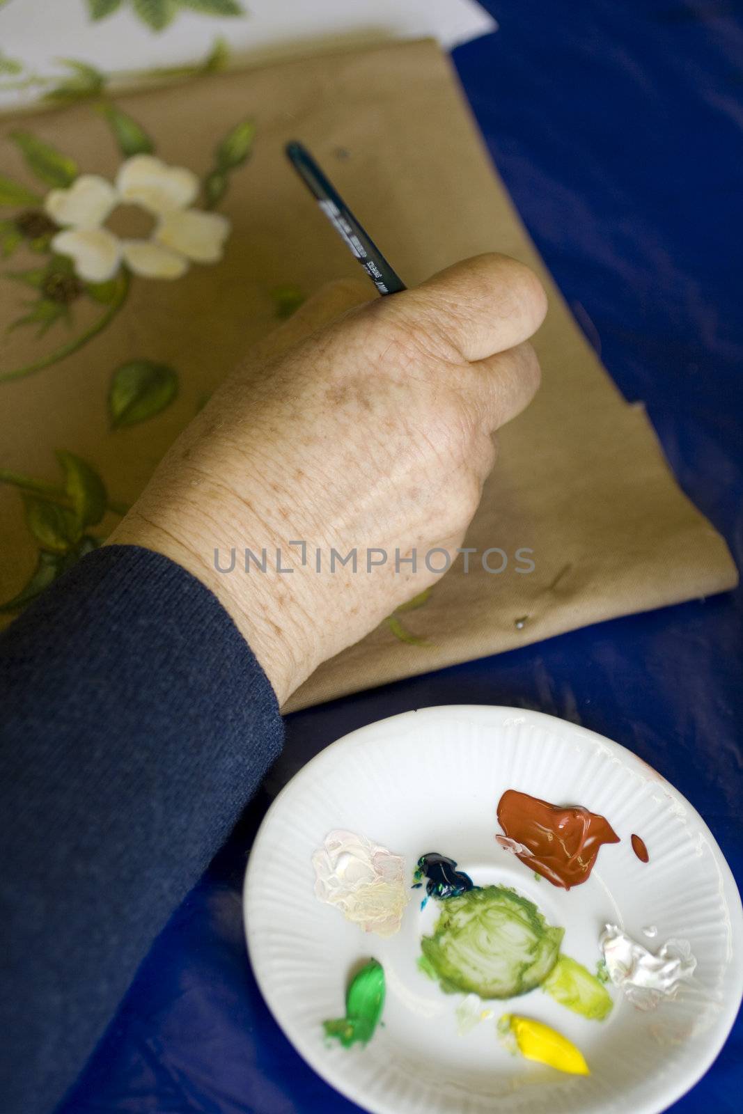 Artist painting flowers on fabric