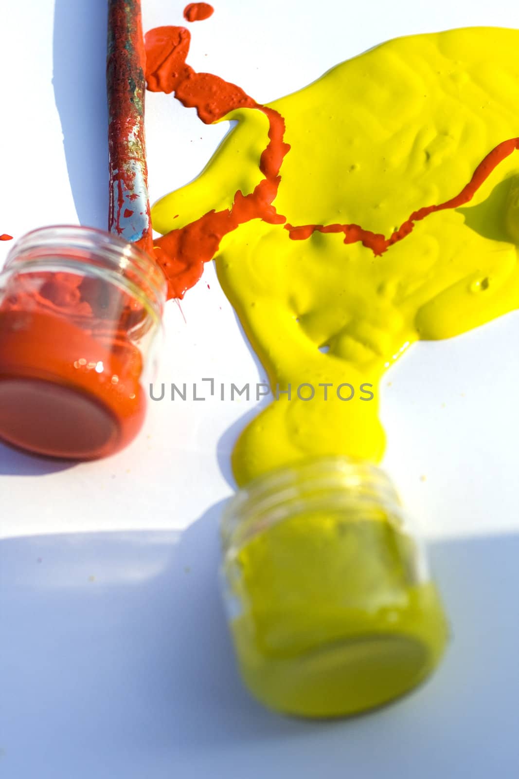 Photo of Yellow and red colors and paintbrush