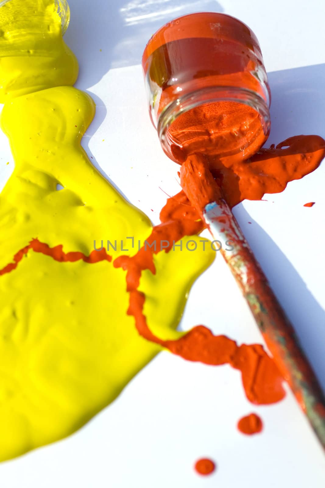 Photo of Yellow and red colors and paintbrush