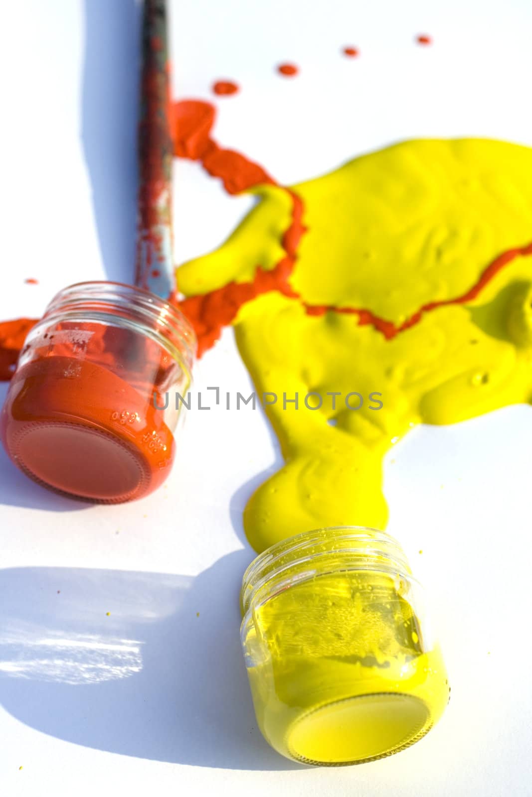 Photo of Yellow and red colors and paintbrush