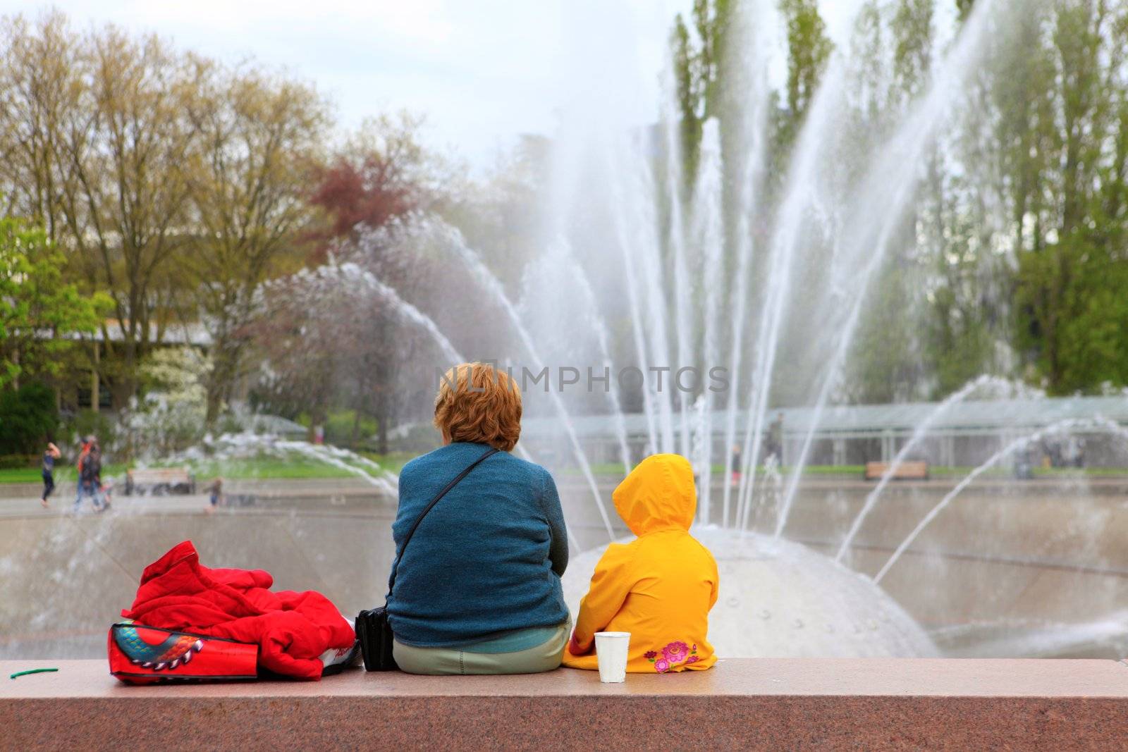 SEATTLE CENTER INTERNATIONAL FOUNTAIN during spring with woman and child.