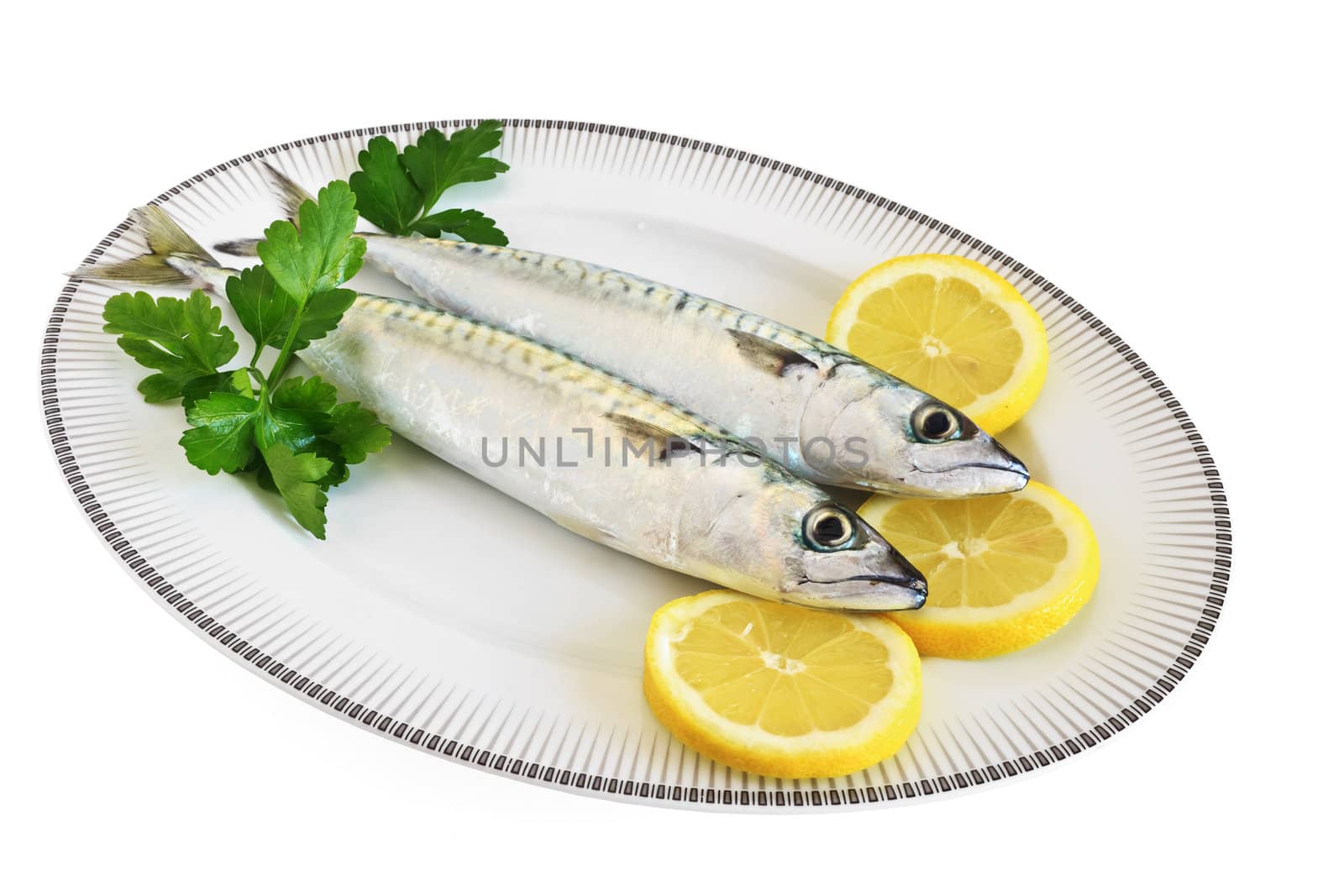 dish with mackerels with lemon and pasley isolated on white background with clipping path