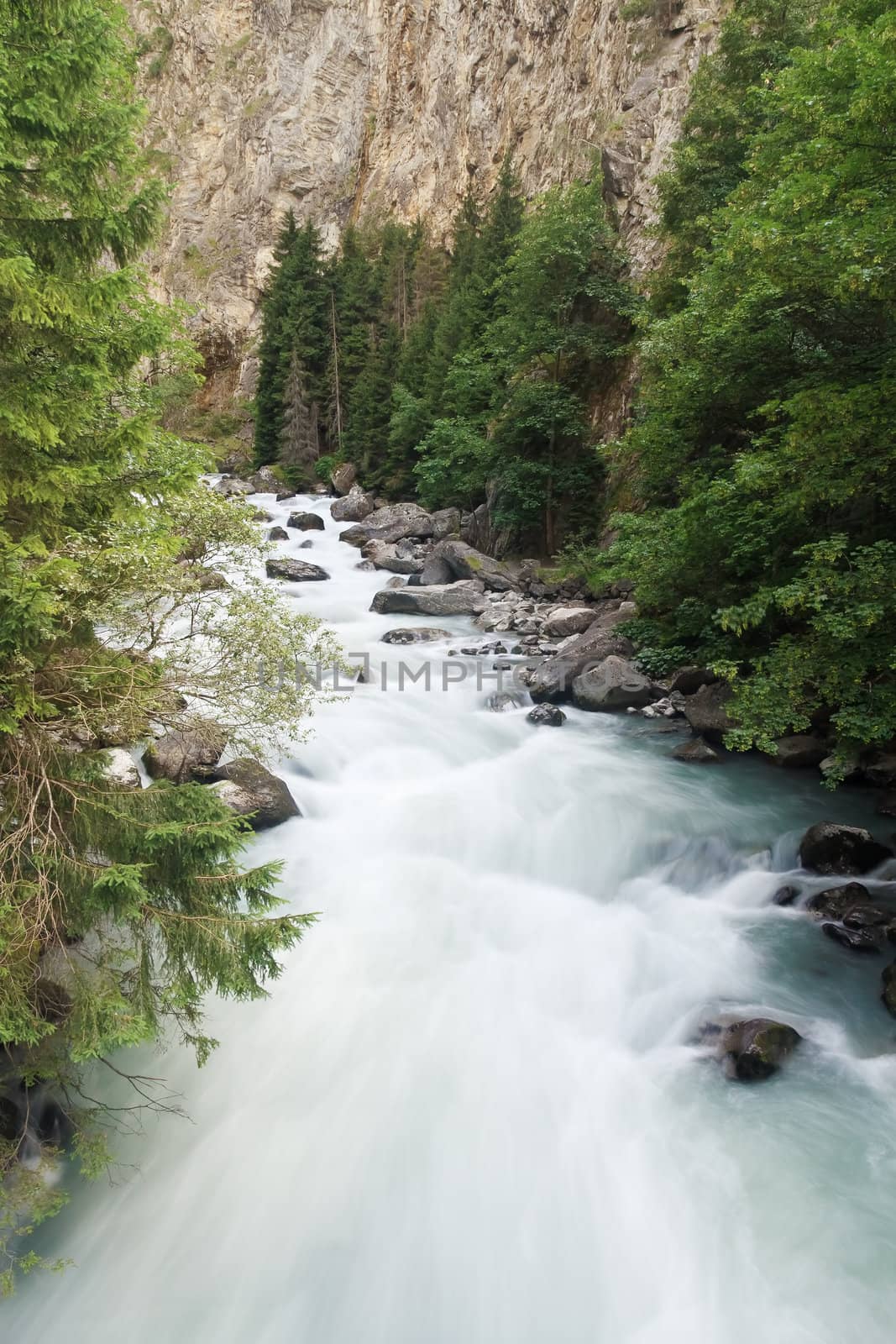 Dora stream between rocks in Pre Saint Didier, Aosta. Italy
