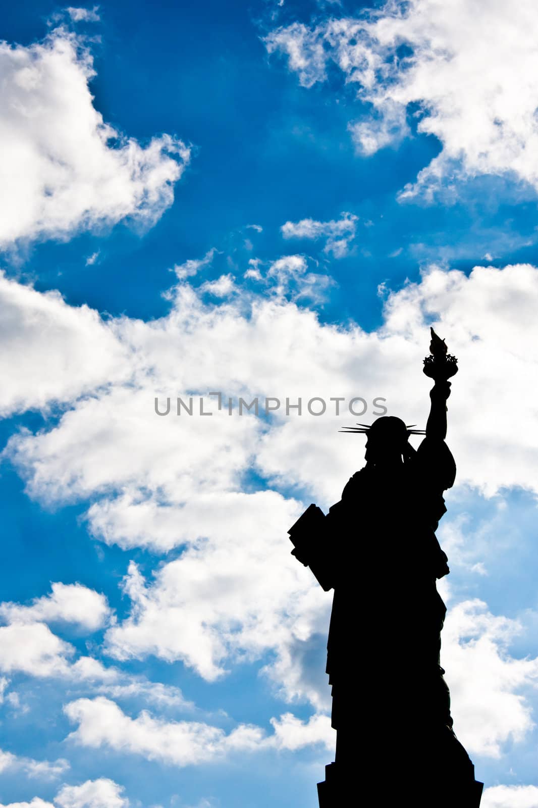 Sunnny day, blue sky with clouds: statue of Liberty with copy space