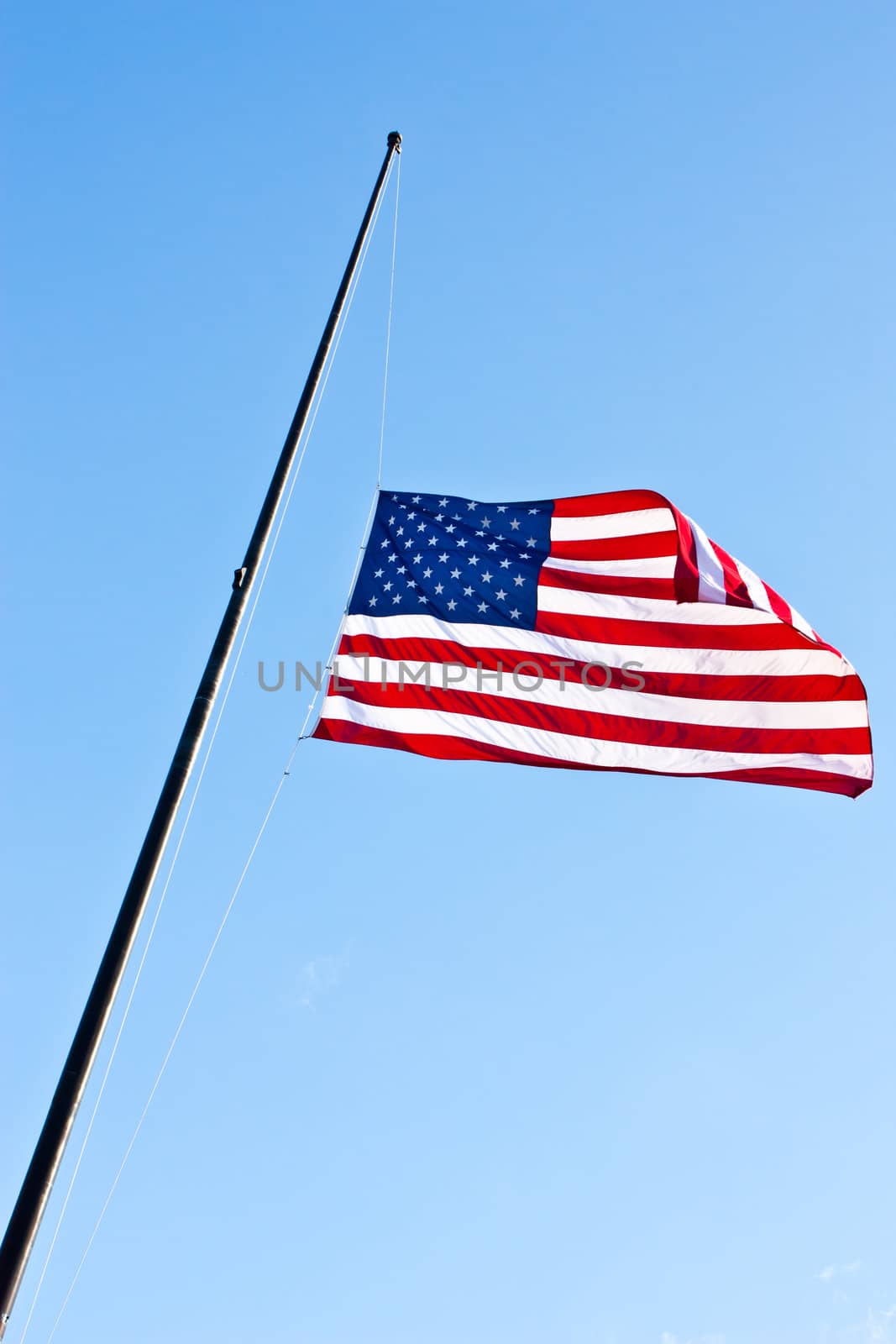 American flag on a blue sky during a windy day