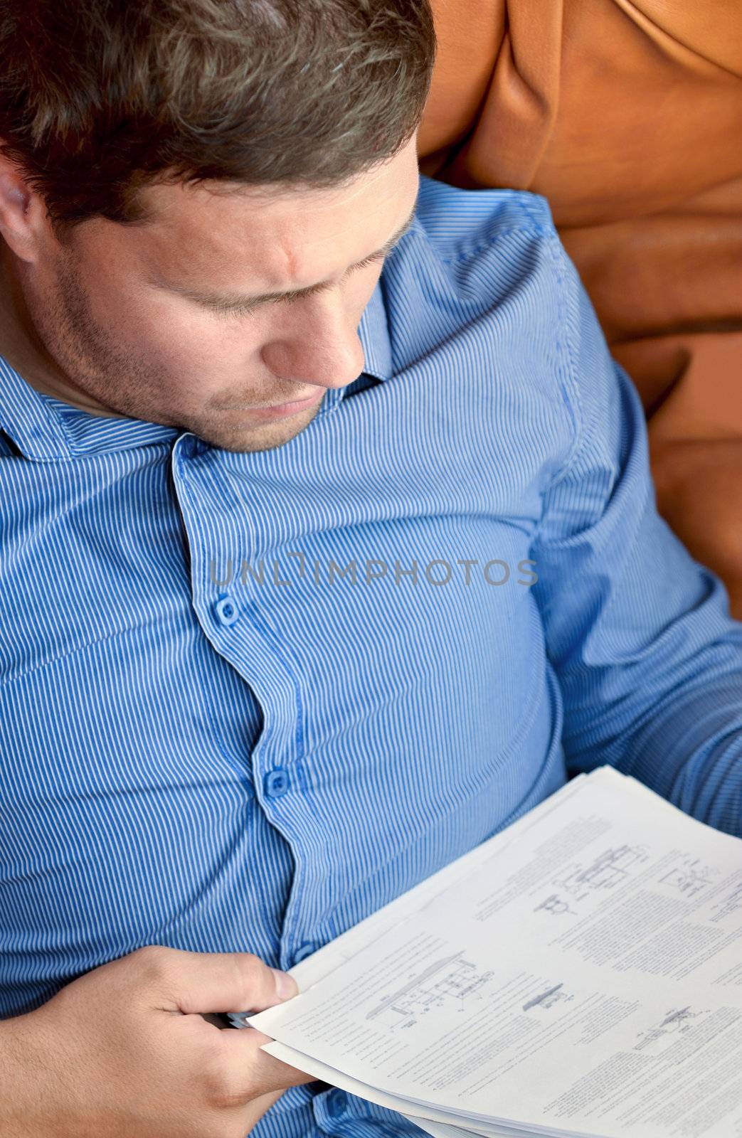Young businessman analyzing some sheets
