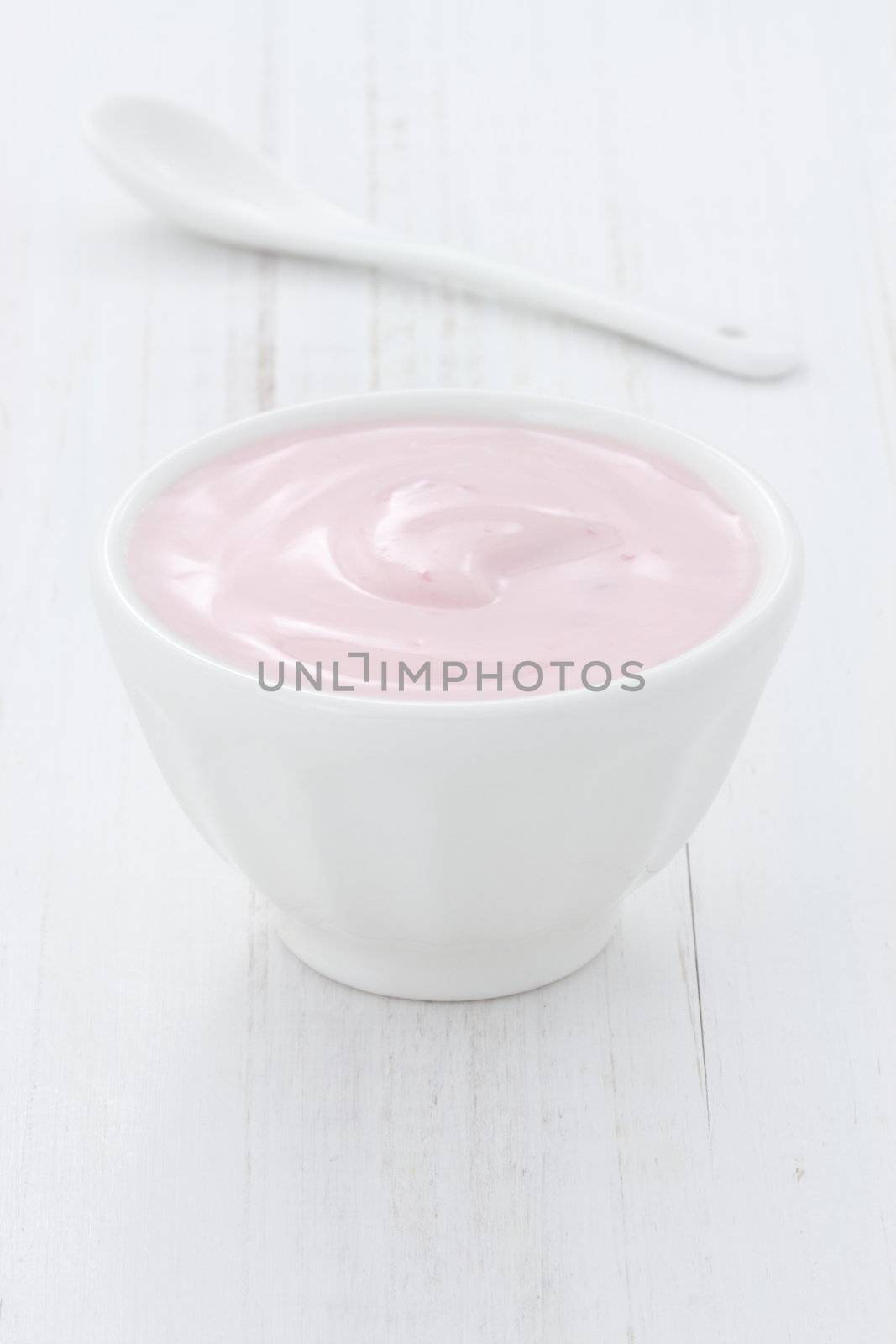 Fresh, healthy and delicious creamy, strawberry yogurt in vintage French cup, the perfect snack or dessert.