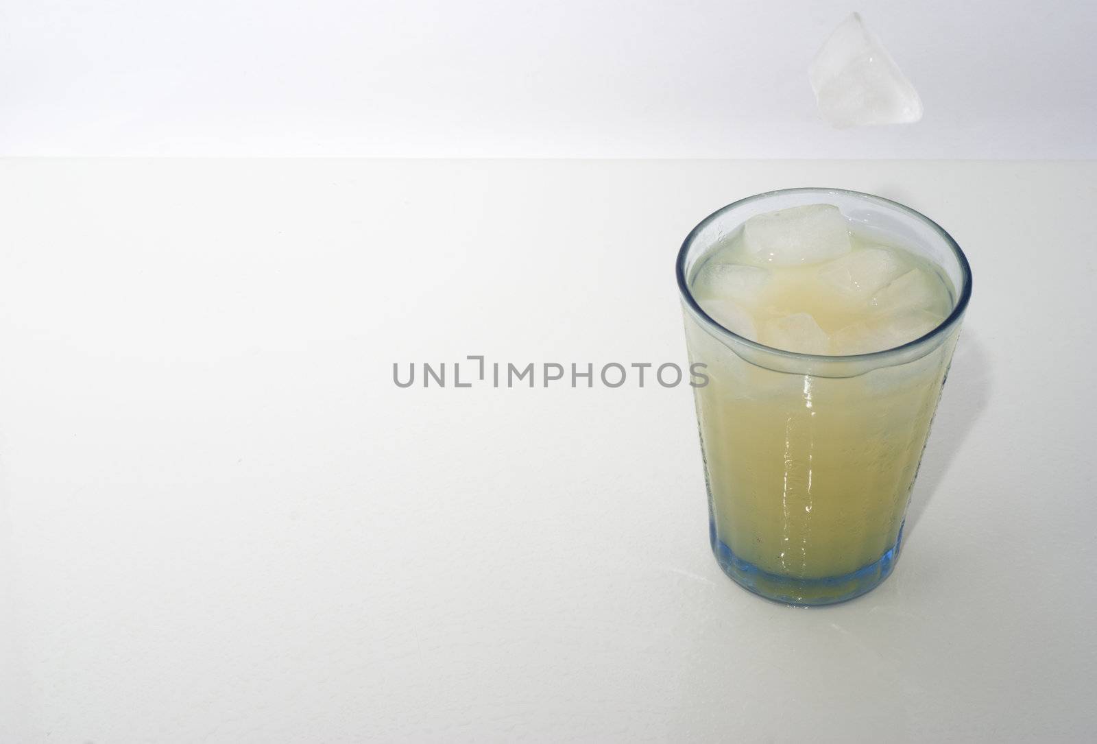 elegant cocktail glass with ice cube  on white  background