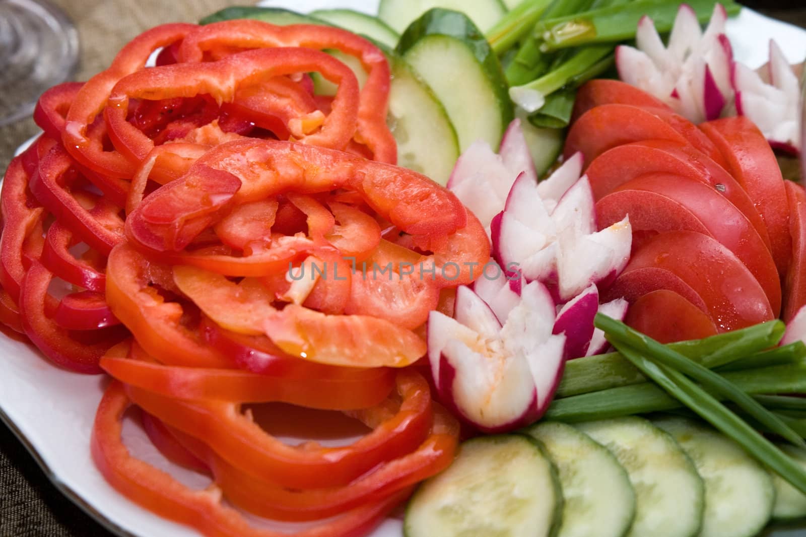 Salad from tomatoes, cucumbers, a garden radish, an onions 