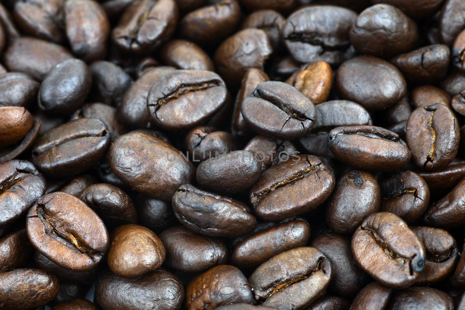 Food and drink background: beautiful detailed macro shot of dark roast coffee beans.