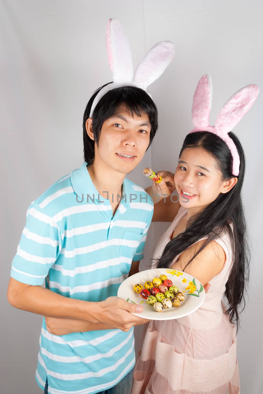 Asian bunny lovers hold Easter eggs  pierced on Ester day.