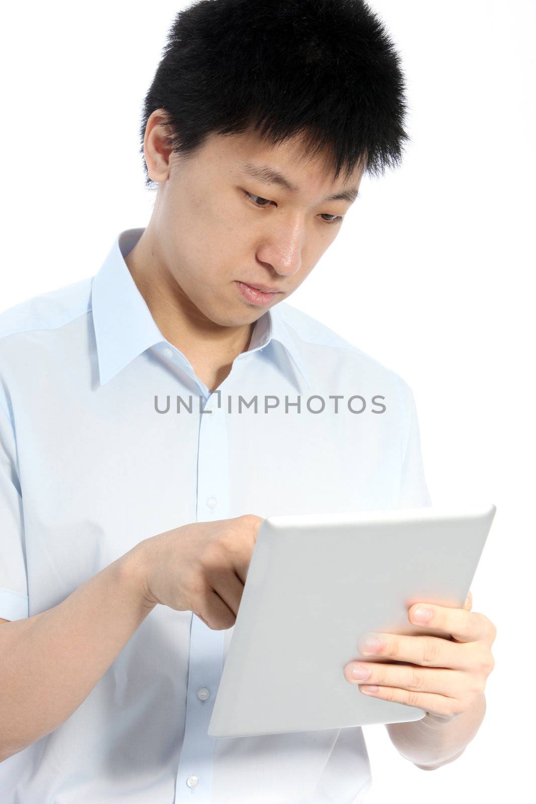 Portrait of a man searching on his tablet against the white background