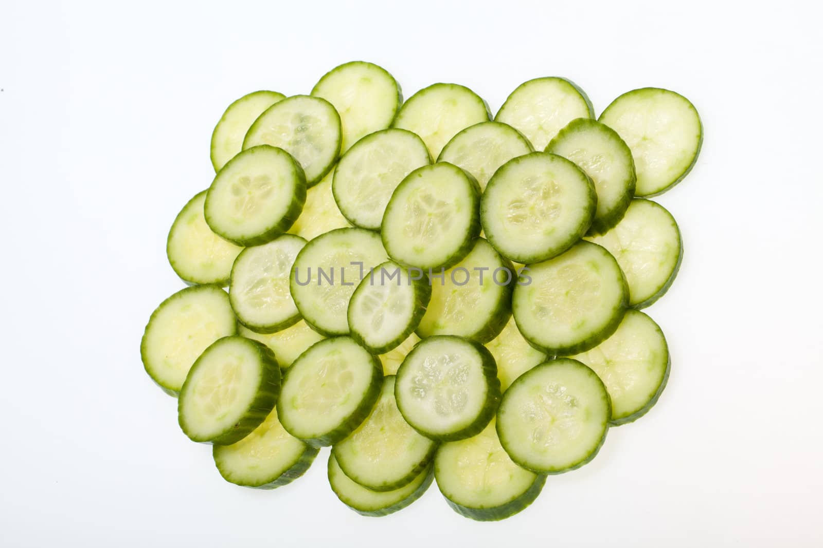 Freshly sliced cucumber  isolated on white background 