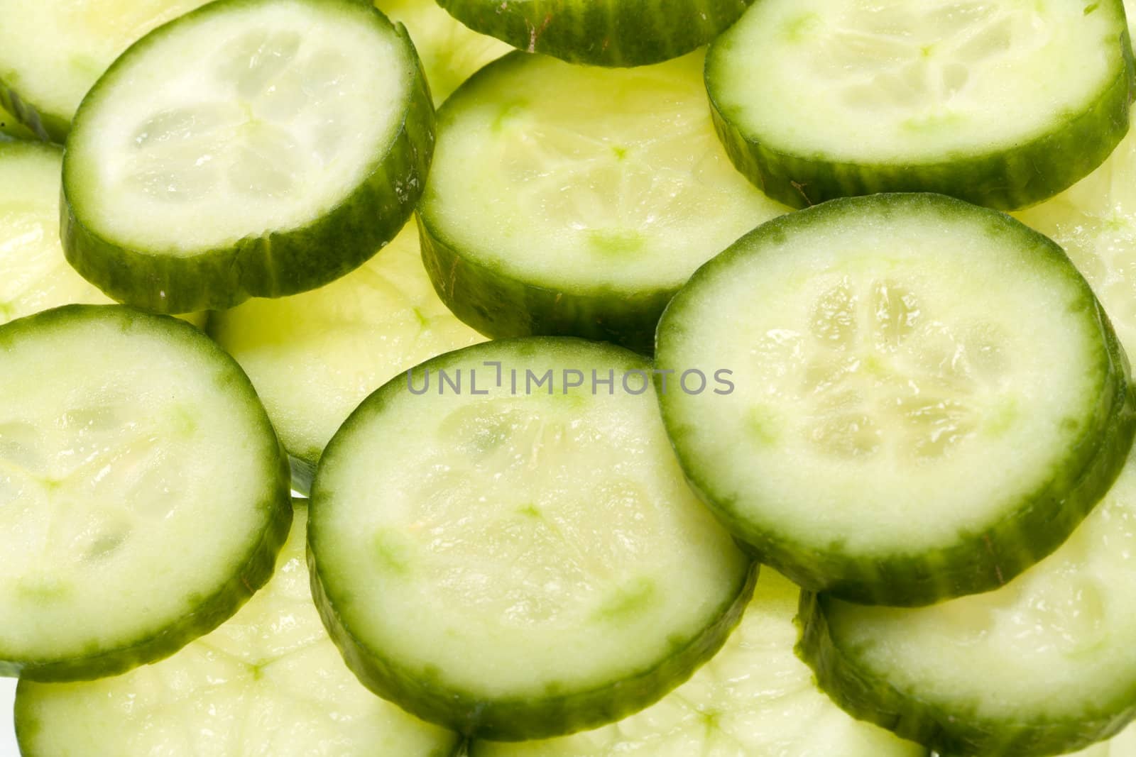Freshly sliced cucumber  isolated on white background 