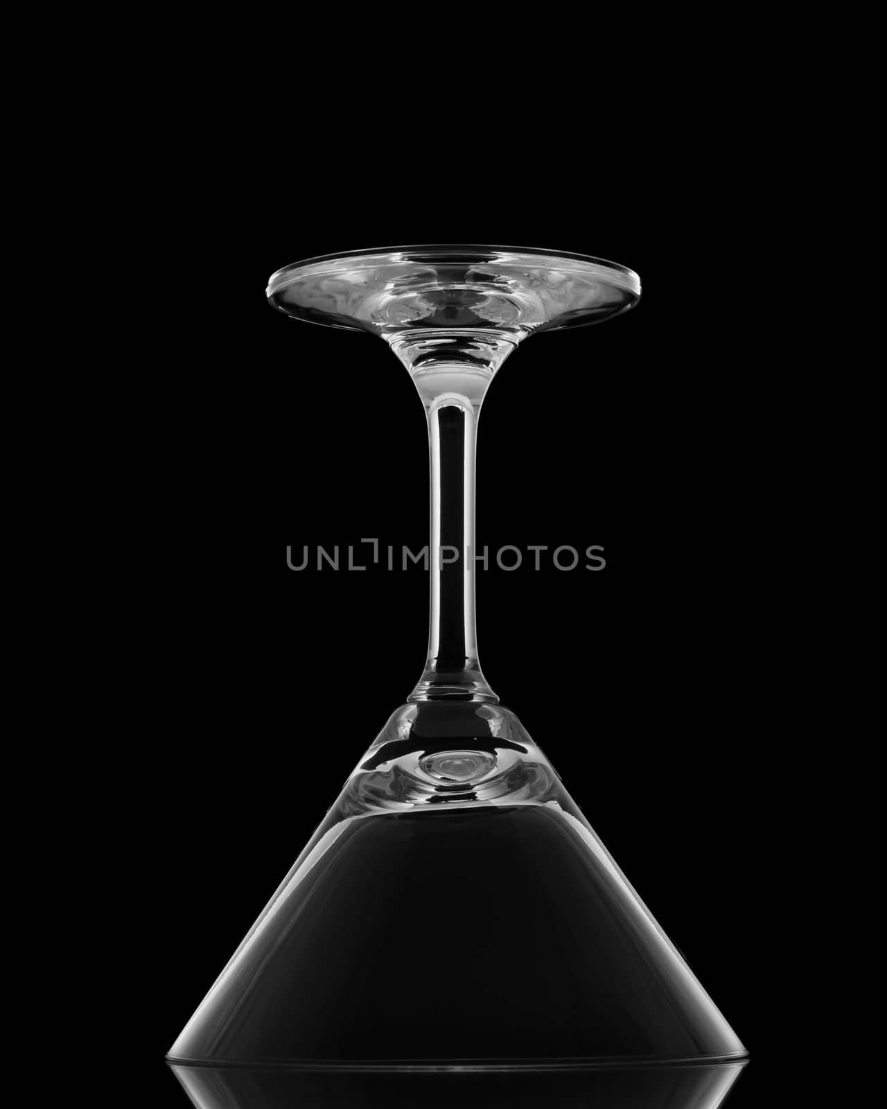 Cocktail glasses upside down on black background and reflection