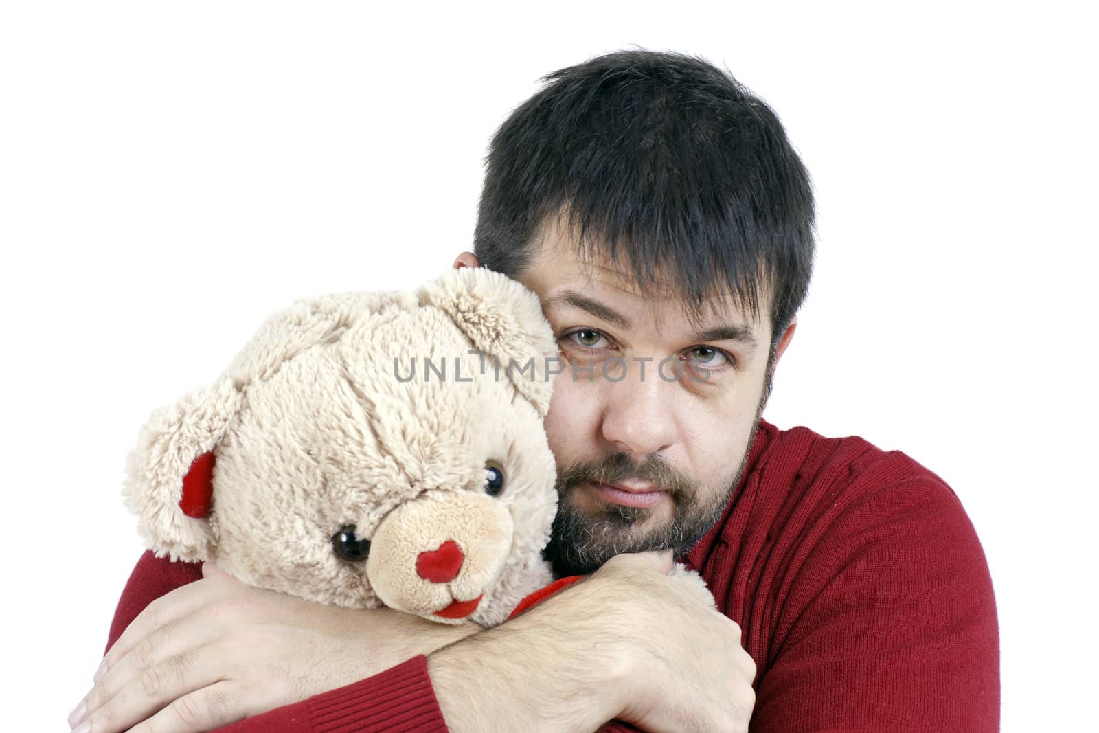 Contradiction: big tough middle age bearded man giveing a big hug to a soft and cute teddy bear.
