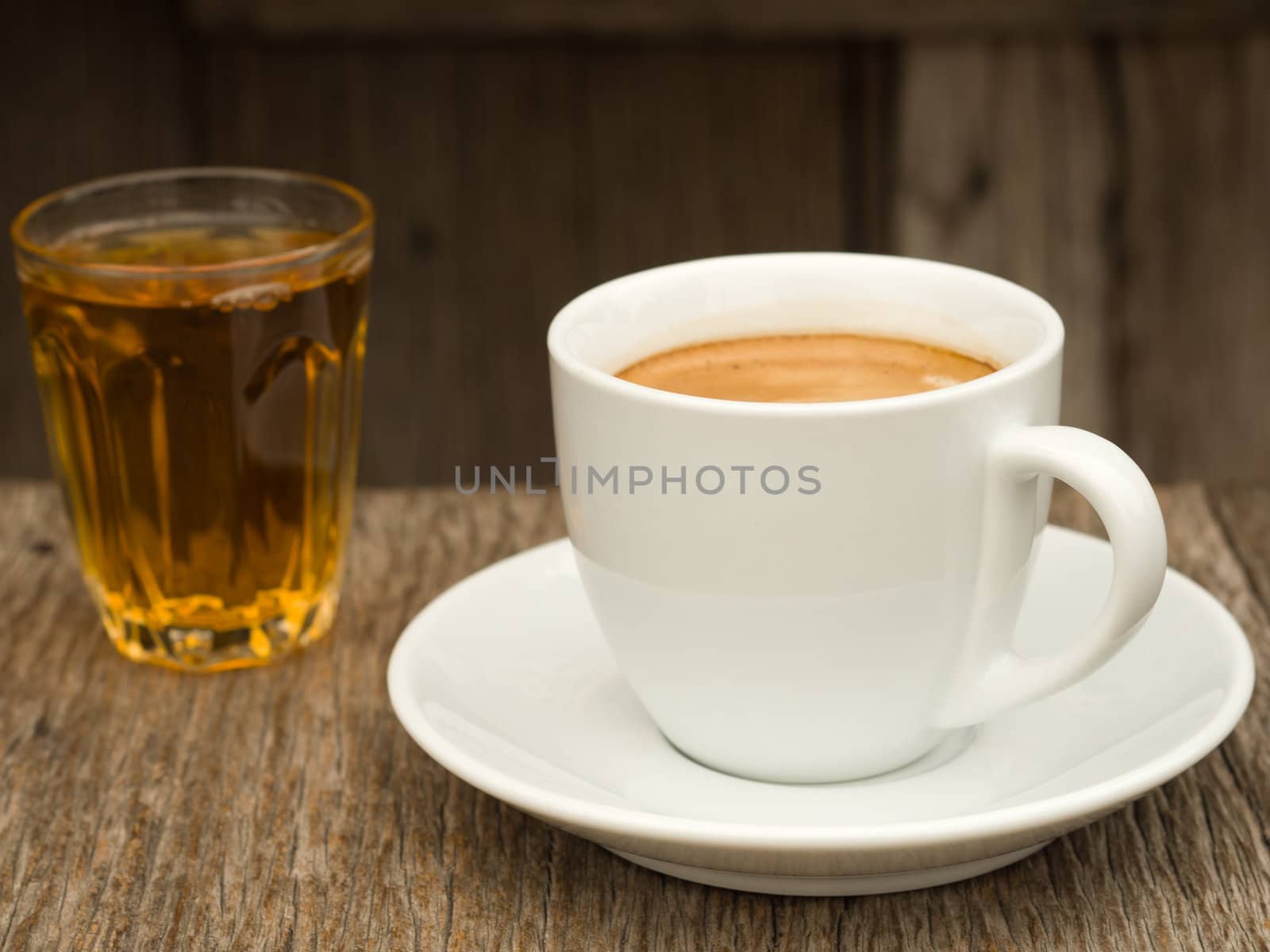 Side view White ceramic Cup of coffee and glass of tea on Wood table