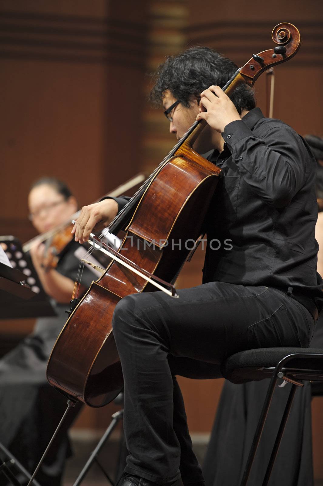 CHENGDU - JUN 20: violoncellist perform on wind music chamber music concert at odeum of Sichuan Conservatory of Music on Jun 20,2012 in Chengdu,China.