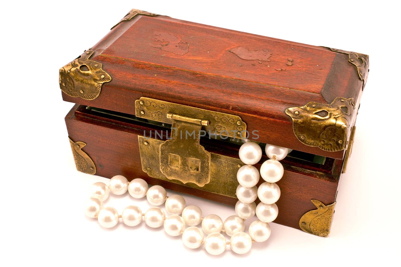 Wooden chest with pearls isolated on white