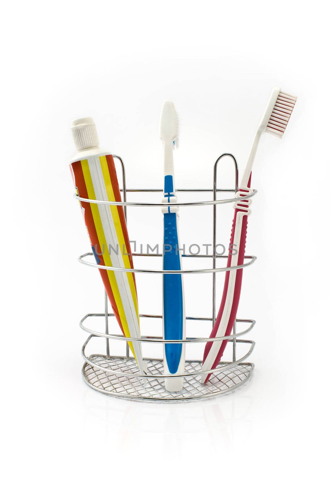 Tooth brushes beside toothpaste isolated on white