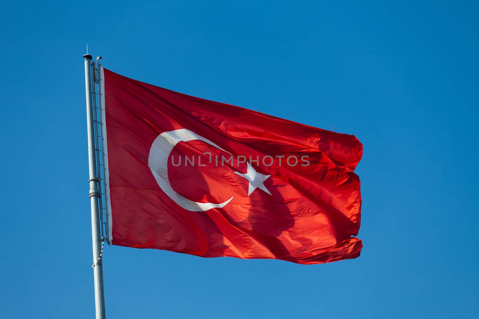 Waving flag of Turkey under blue sky 