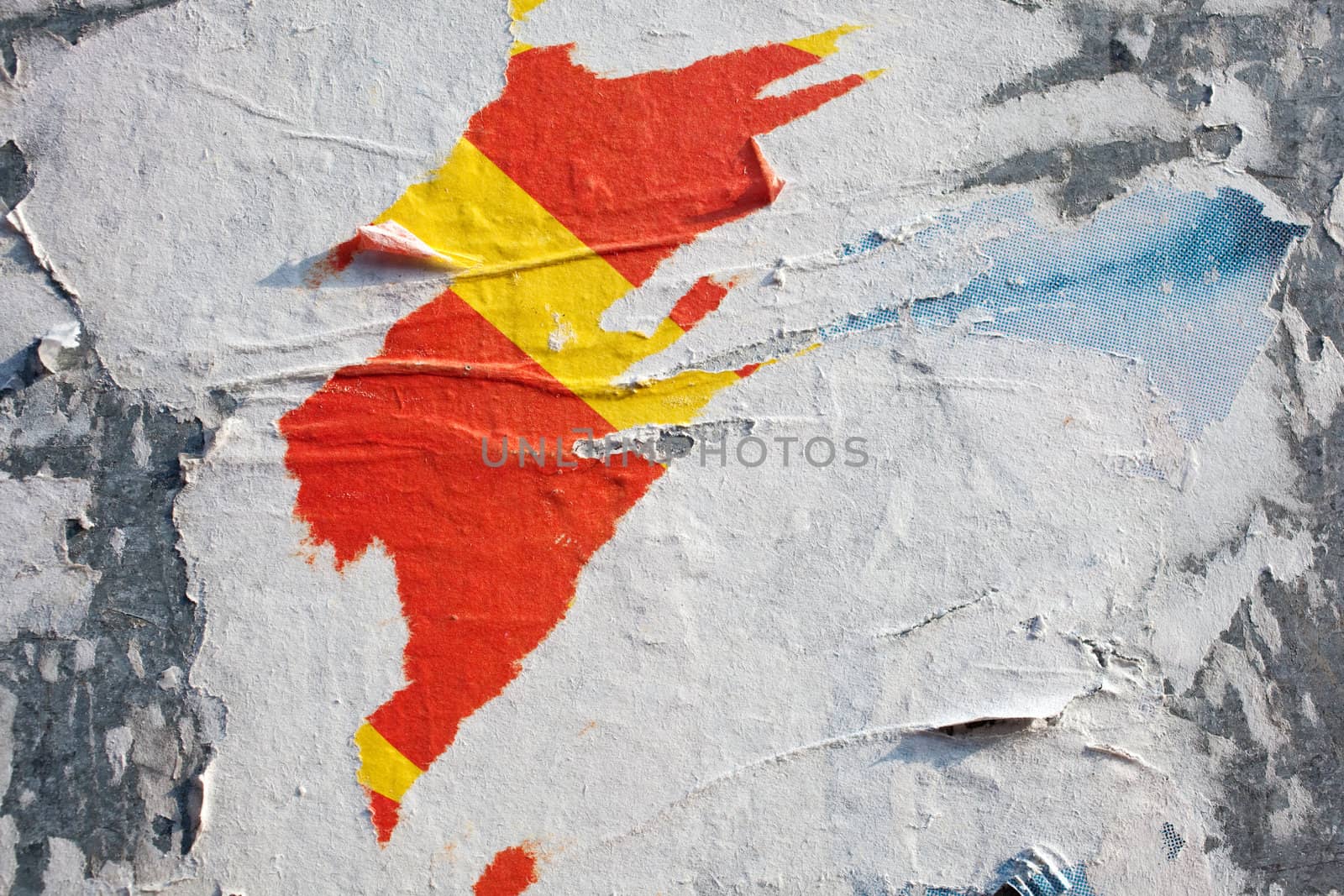 Torn posters on a iron surface