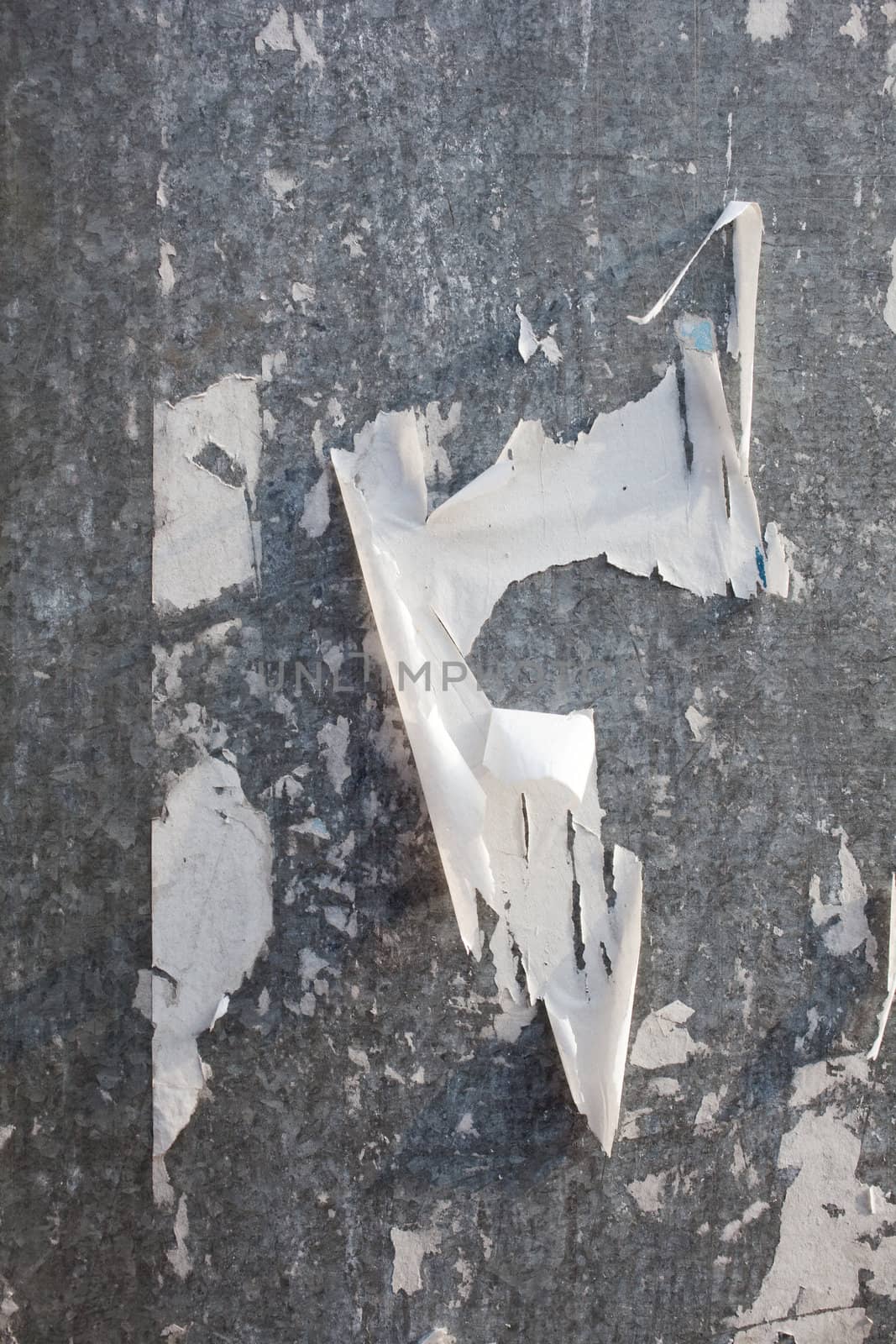 Torn posters on a iron surface
