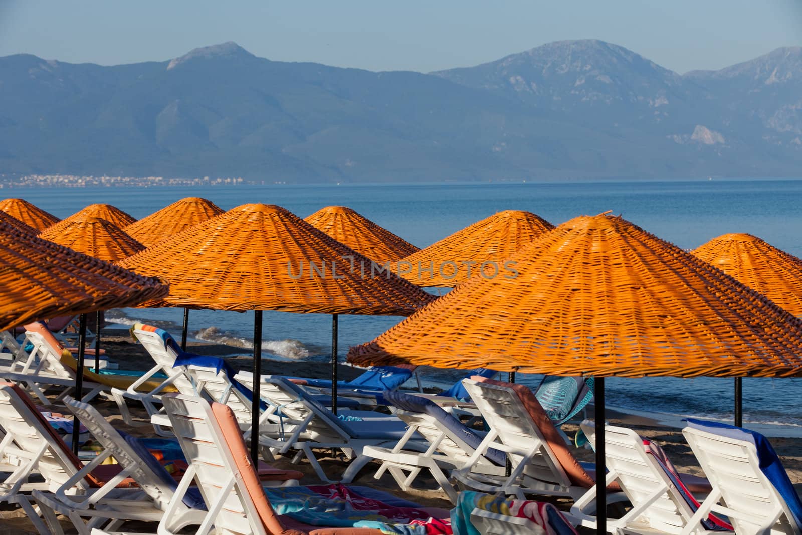 Beach loungers and umbrellas on the sea.