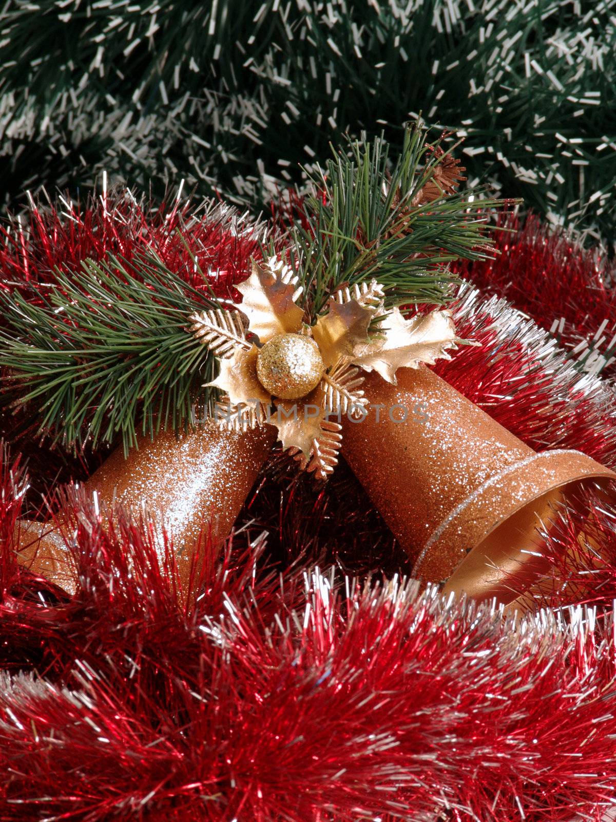 Decorative gold christmas campanellis on a background garlands                               