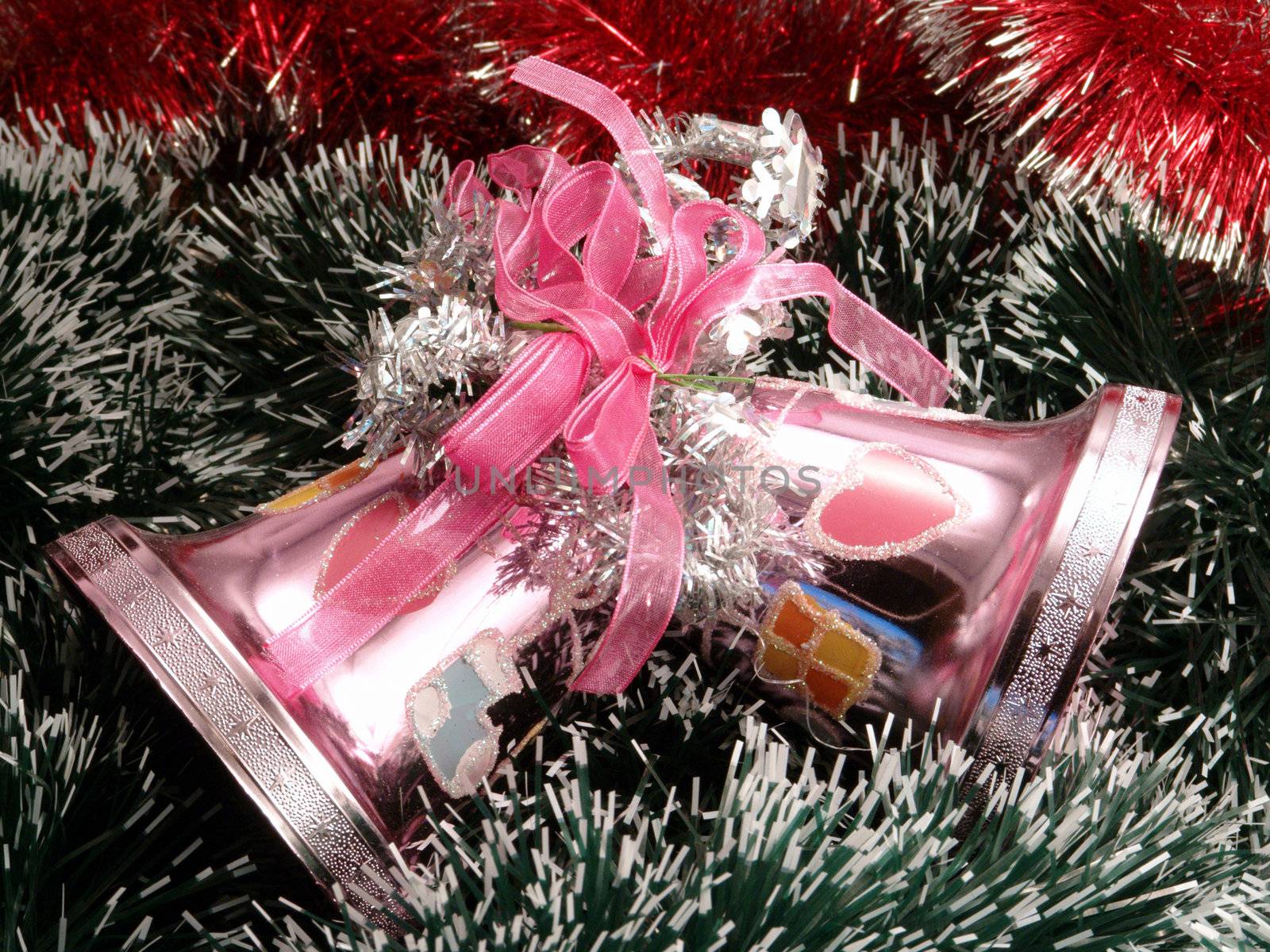 Decorative pink christmas campanellis on a background garlands                               