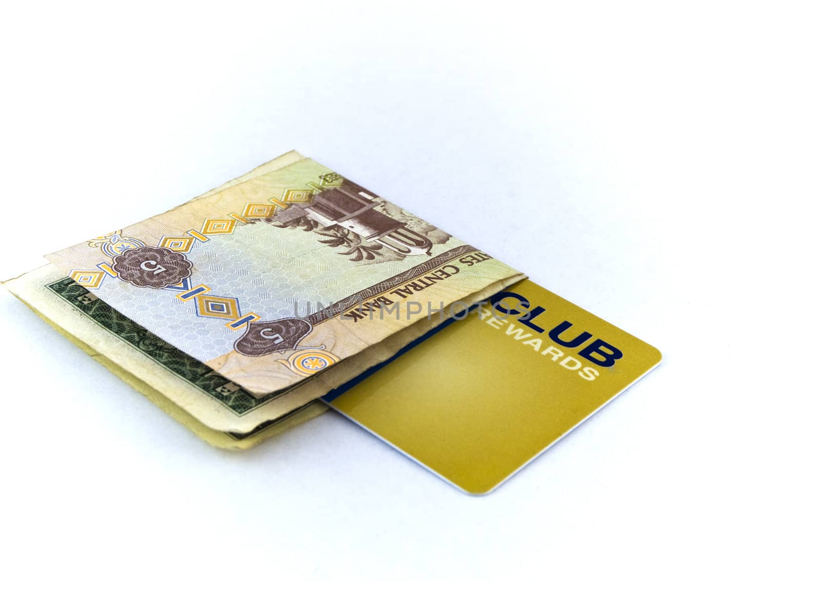 Five Dirham Note and Gold Membership Club Card on White Background