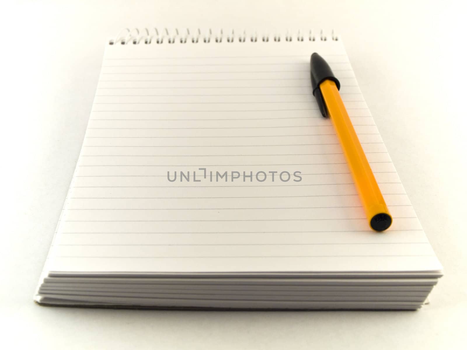 Ballpoint Pen and Notepad on White Background by bobbigmac