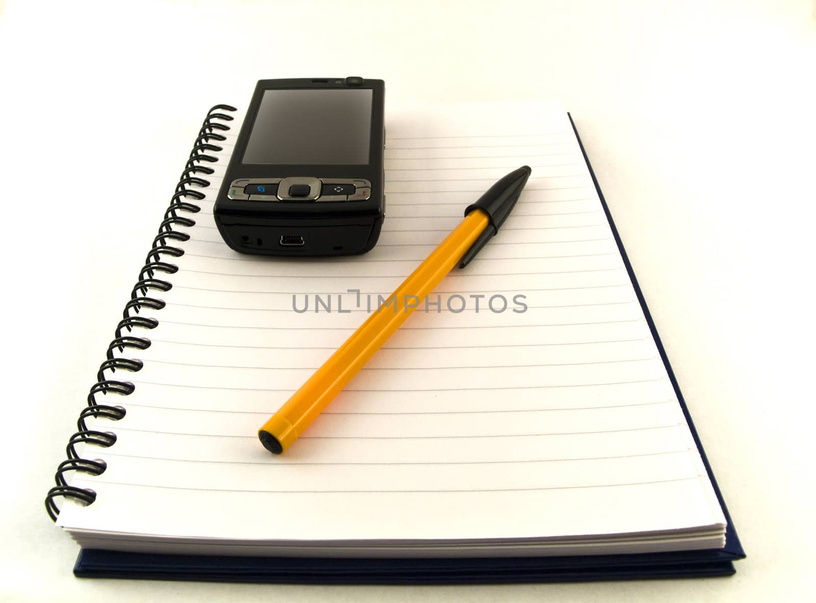 Ballpoint Pen and Mobile Phone on Notebook White Background