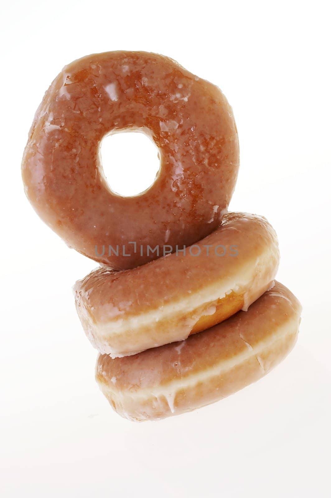 a picture of three glazed donuts