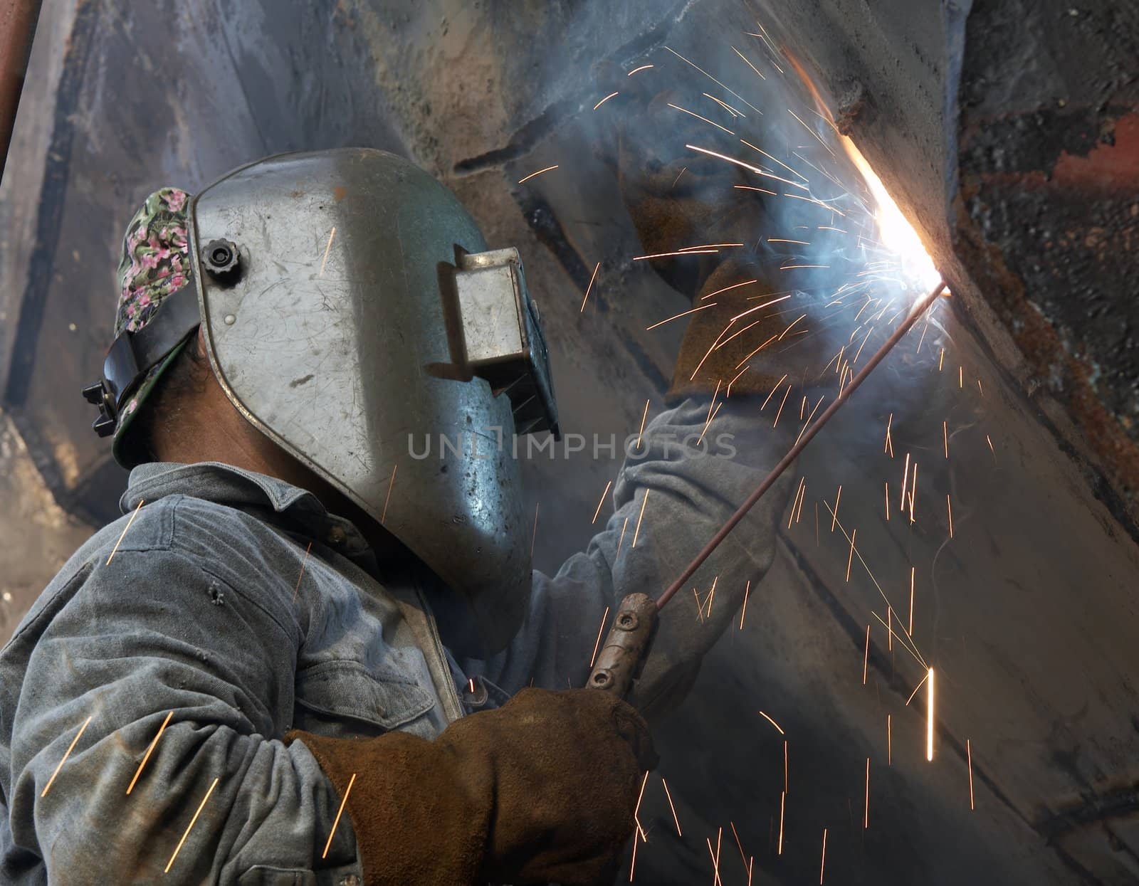 a metal welder busy at work