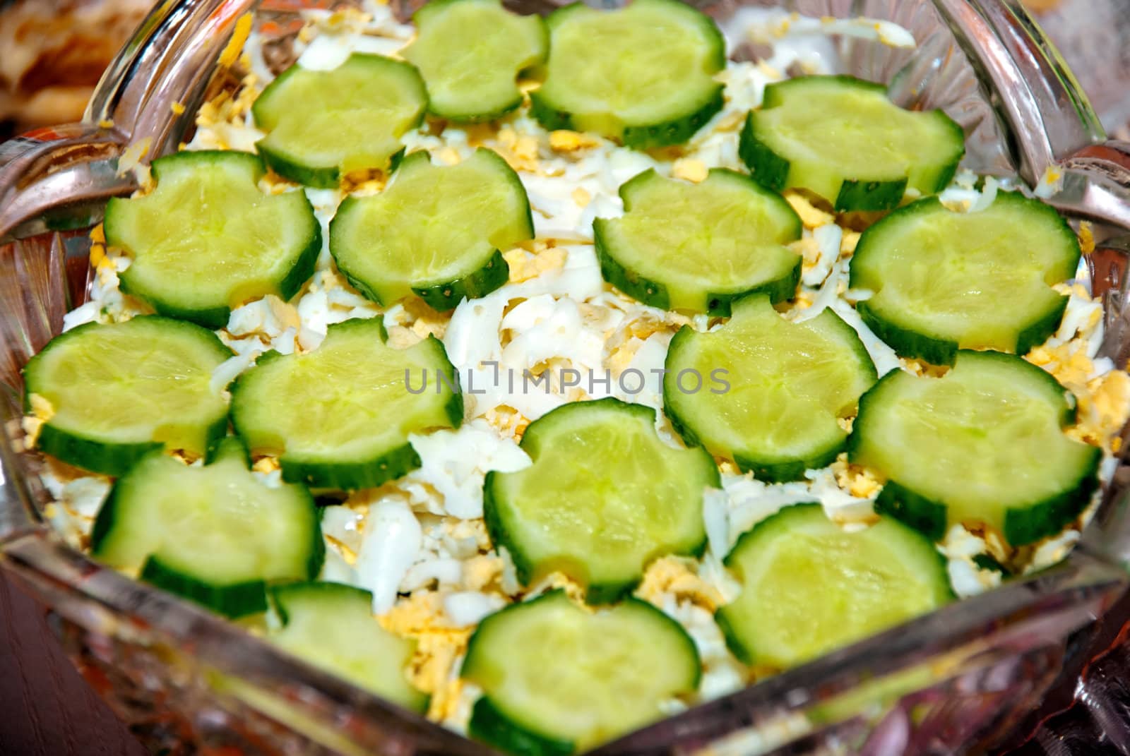 Vegetable fresh salad greens adorned with sliced ​​cucumbers