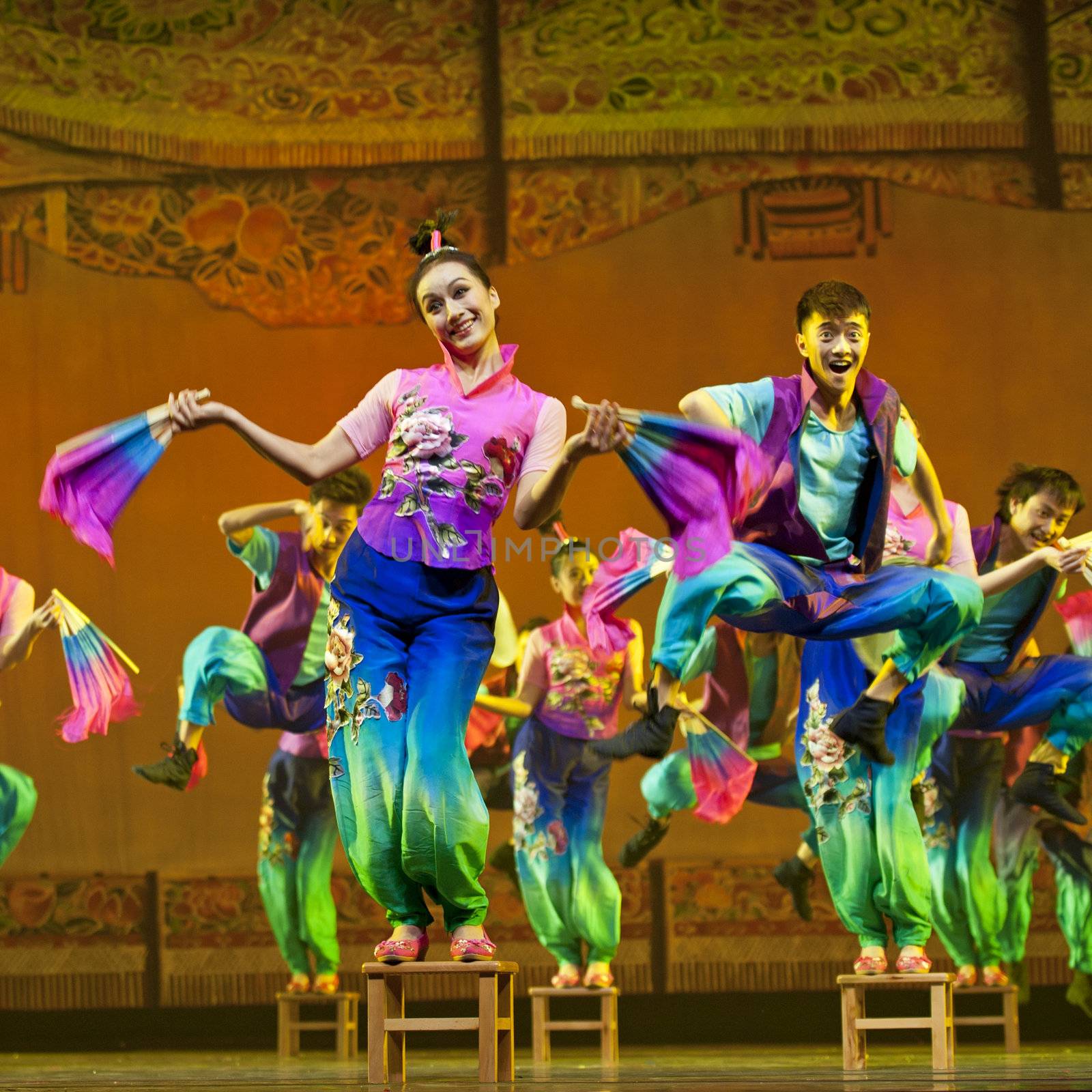 CHENGDU - OCT 17: Chinese national dancers perform folk dance on stage at JINCHENG theater on Oct 17, 2011 in Chengdu, China.