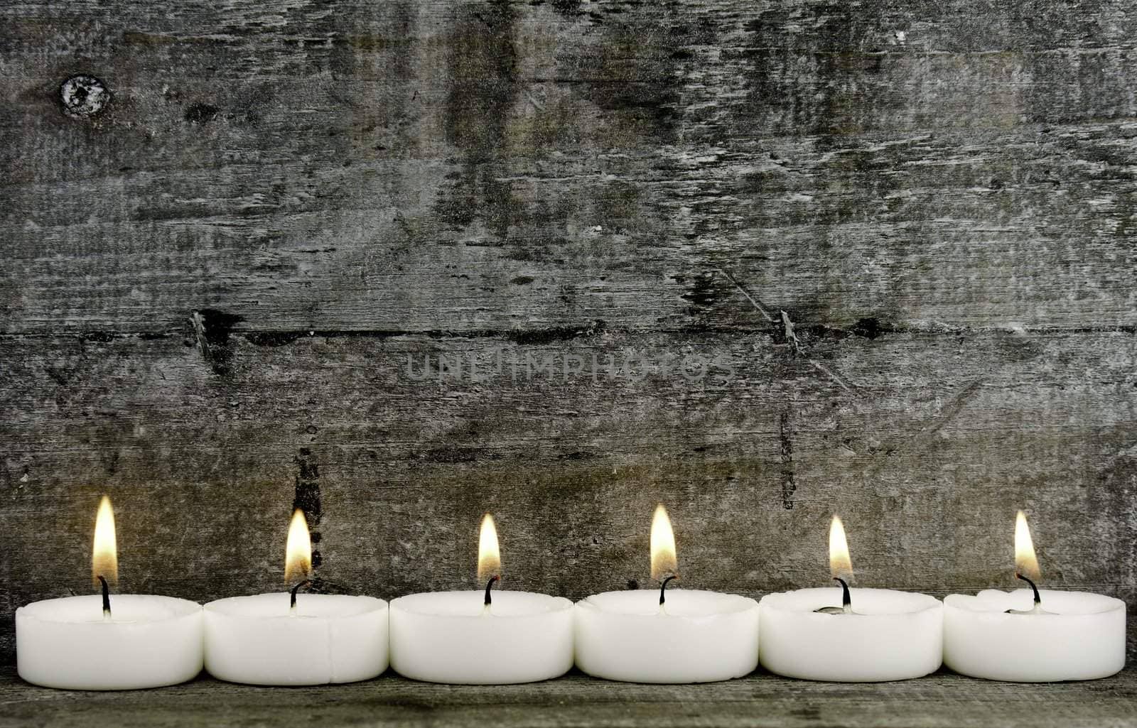 six candles on woodeen background