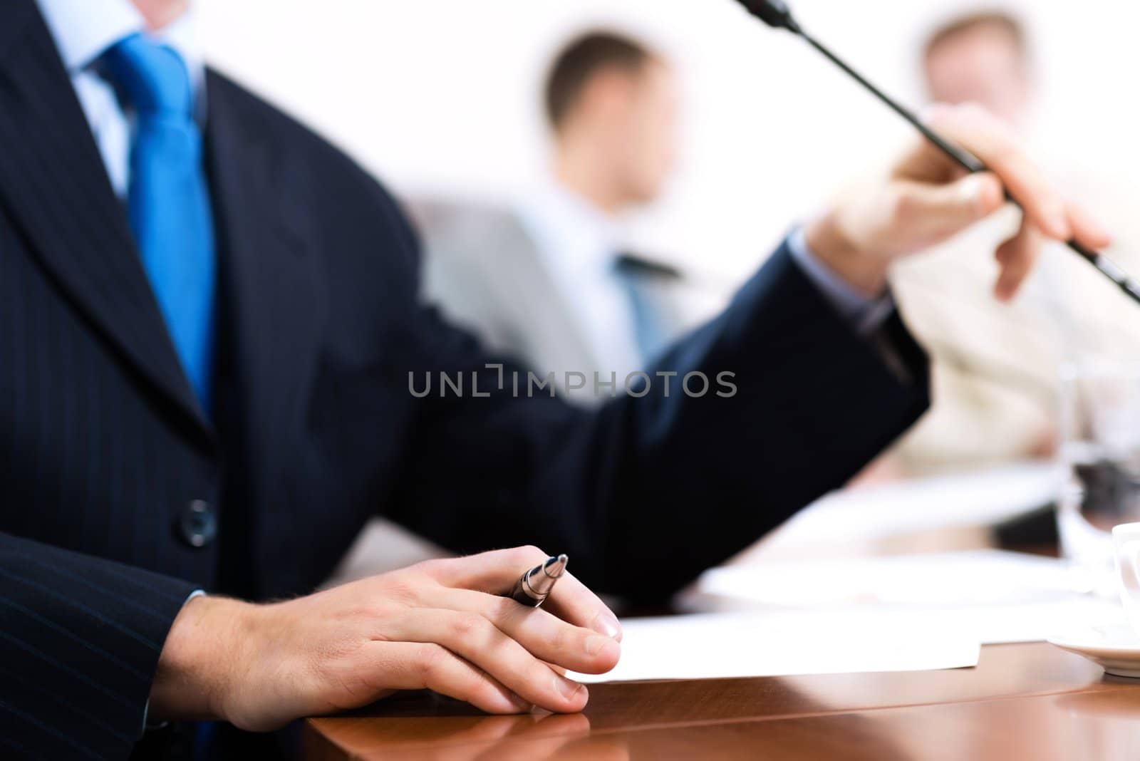 close-up of hand holding a pen, a businessman meeting