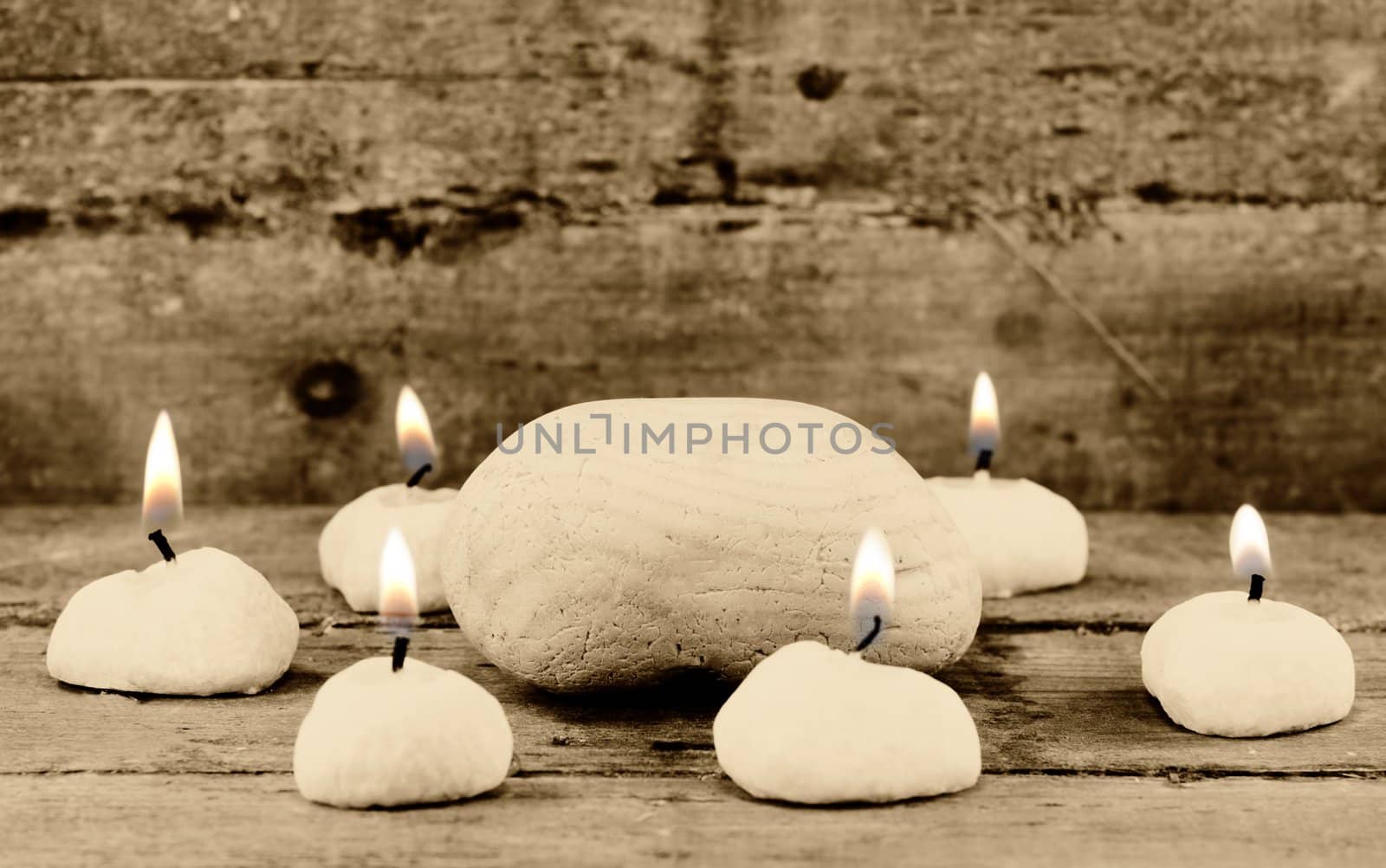 A stone surrounded by candles