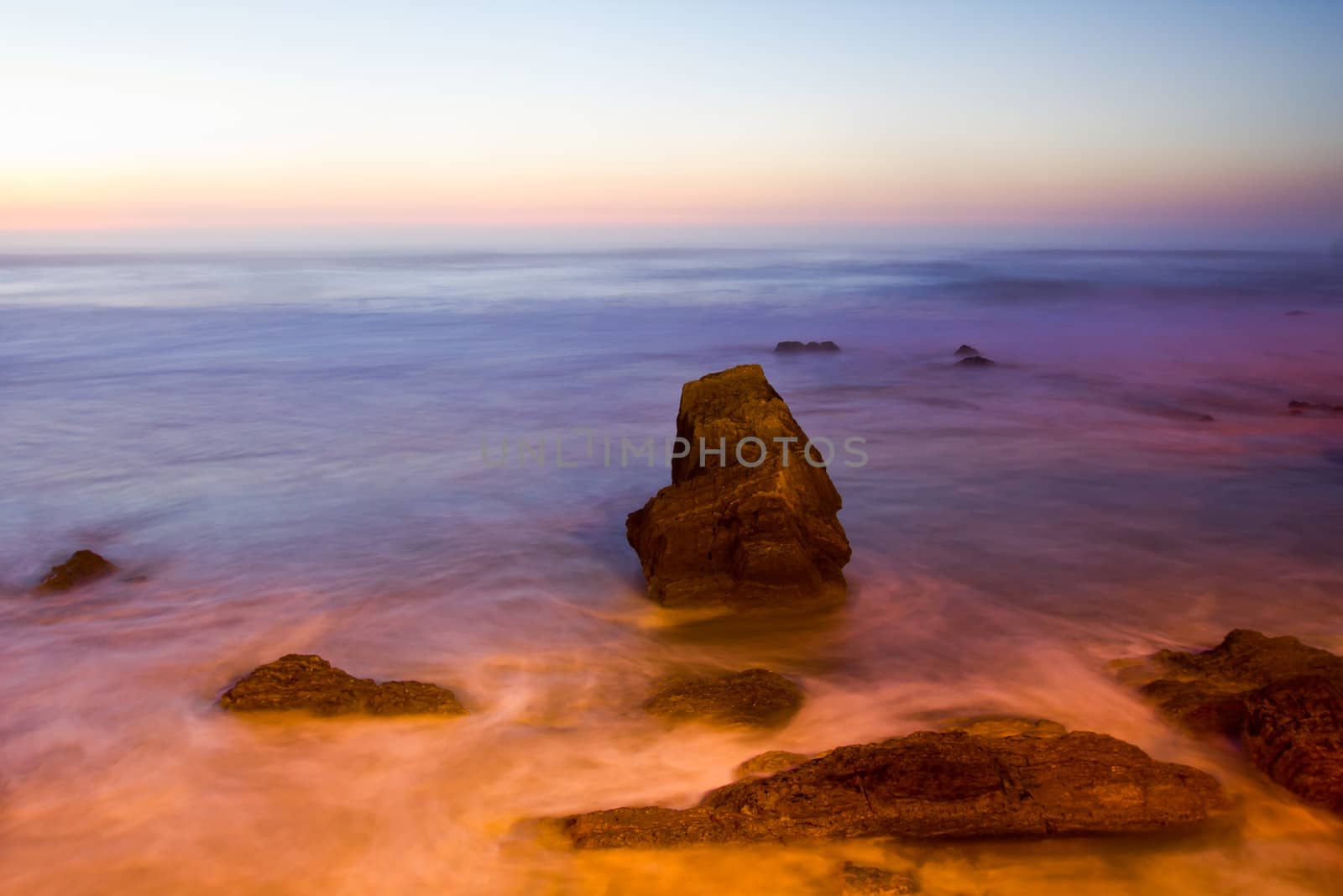 Long exposure view of sunset on the rocky coast. Portugal