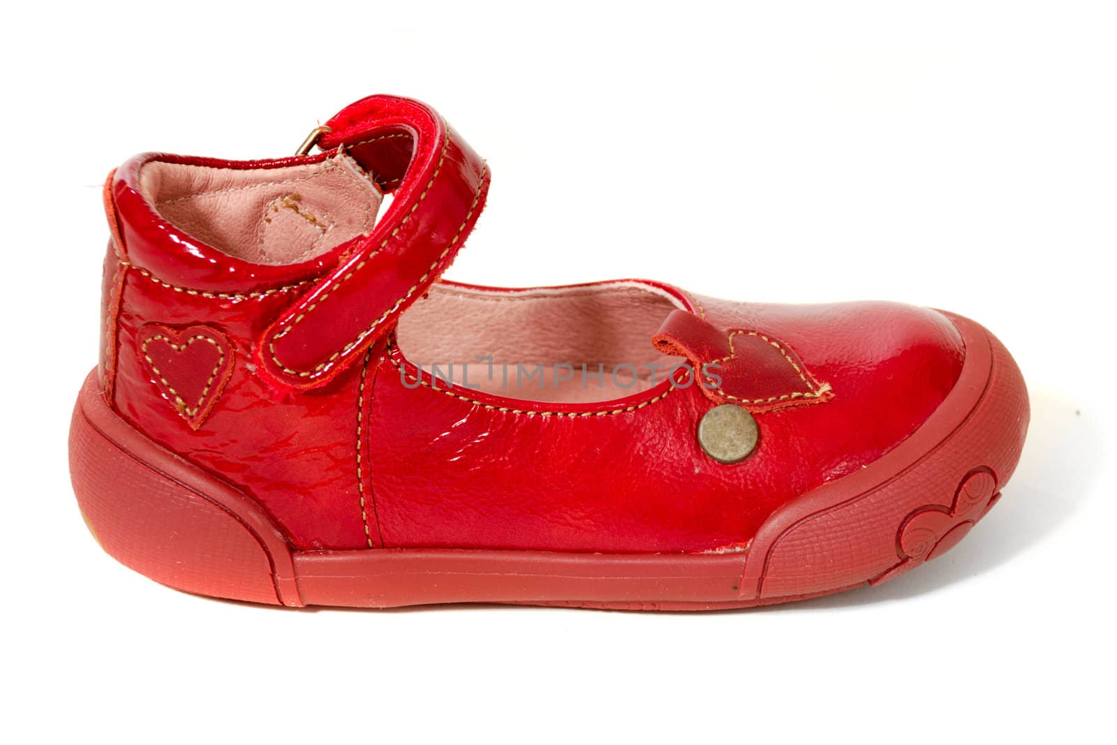 A red childs shoe. Taken on a clean white background.