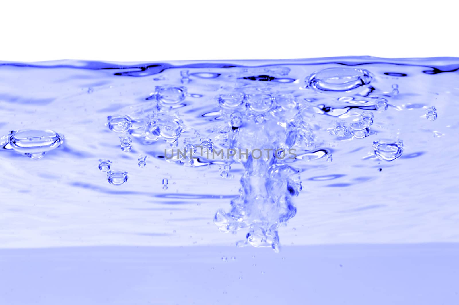 Blue water with air bubbles in the water line. 