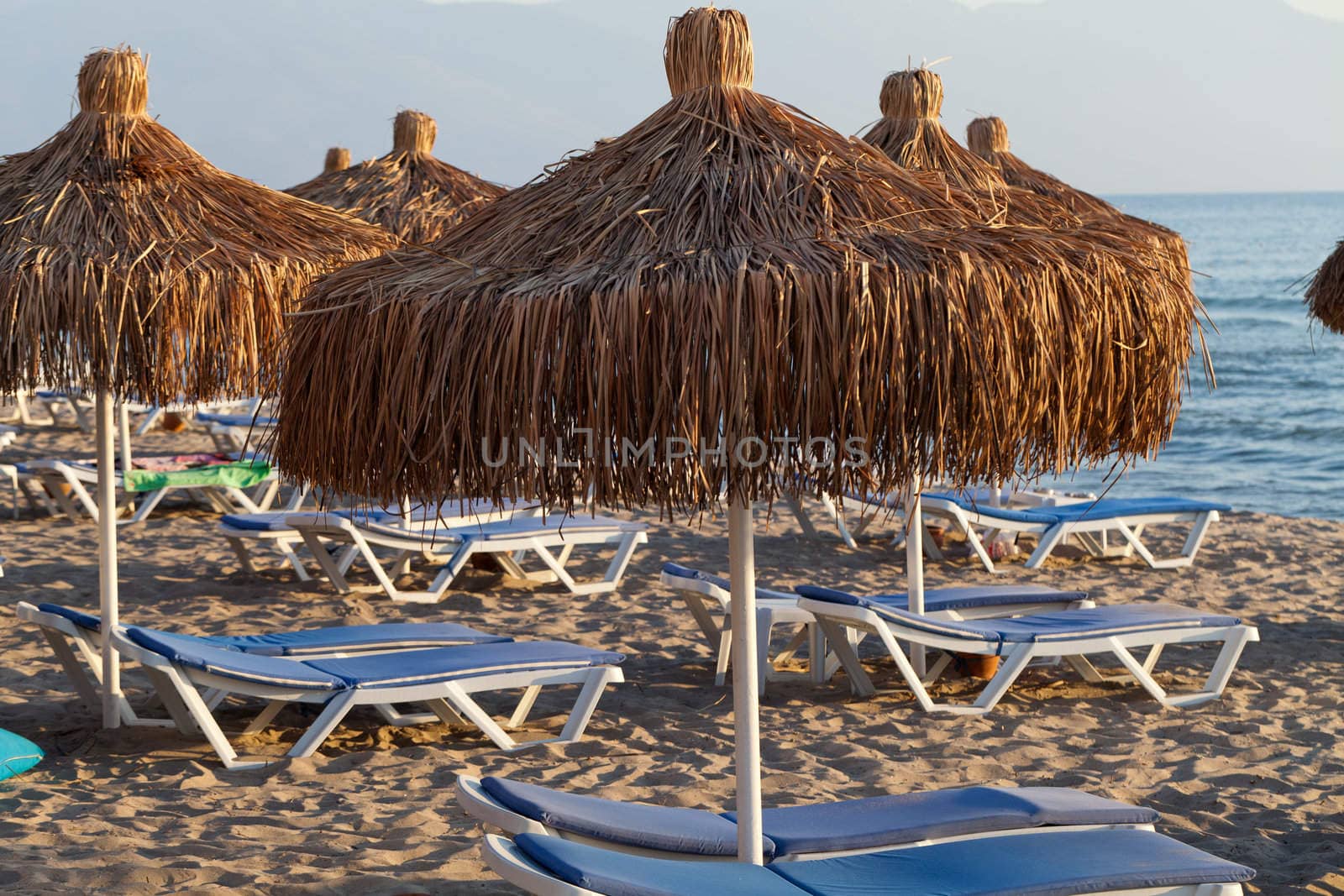 Beach loungers and umbrellas on the sea.