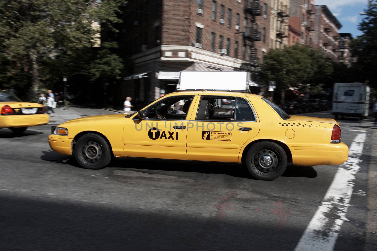New York, Usa - Sep 18th, 2010: New York Taxi driving in Chelsea, Manhattan, NYC. With antique buildings on the background.

Yellow taxi billboard with clipping path. Crowded with commercial signs, there is intense competition for attention in Chelsea, New York City
