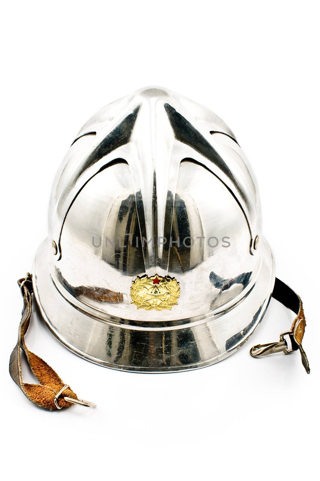 Old fireman's metallic helmet isolated on white