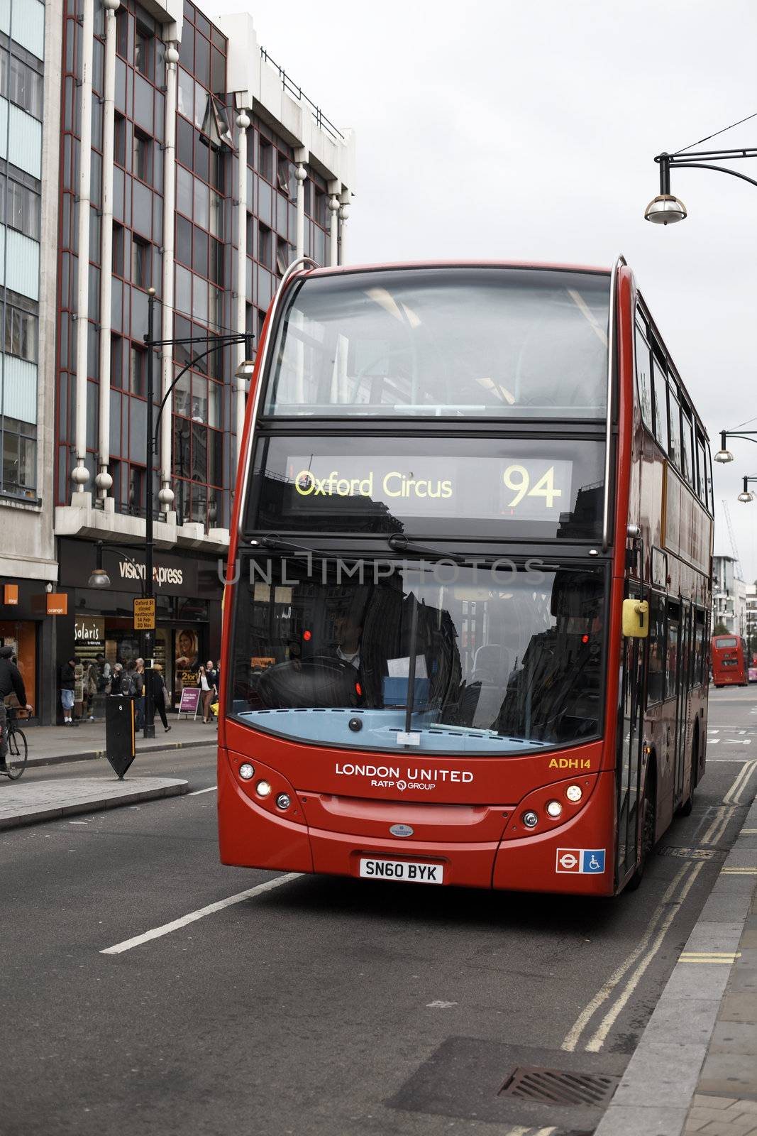 London, United Kingdom - 00 Sep, 2011: Traditional red bus running in a road in the center of the city in direction of Oxford Circus.